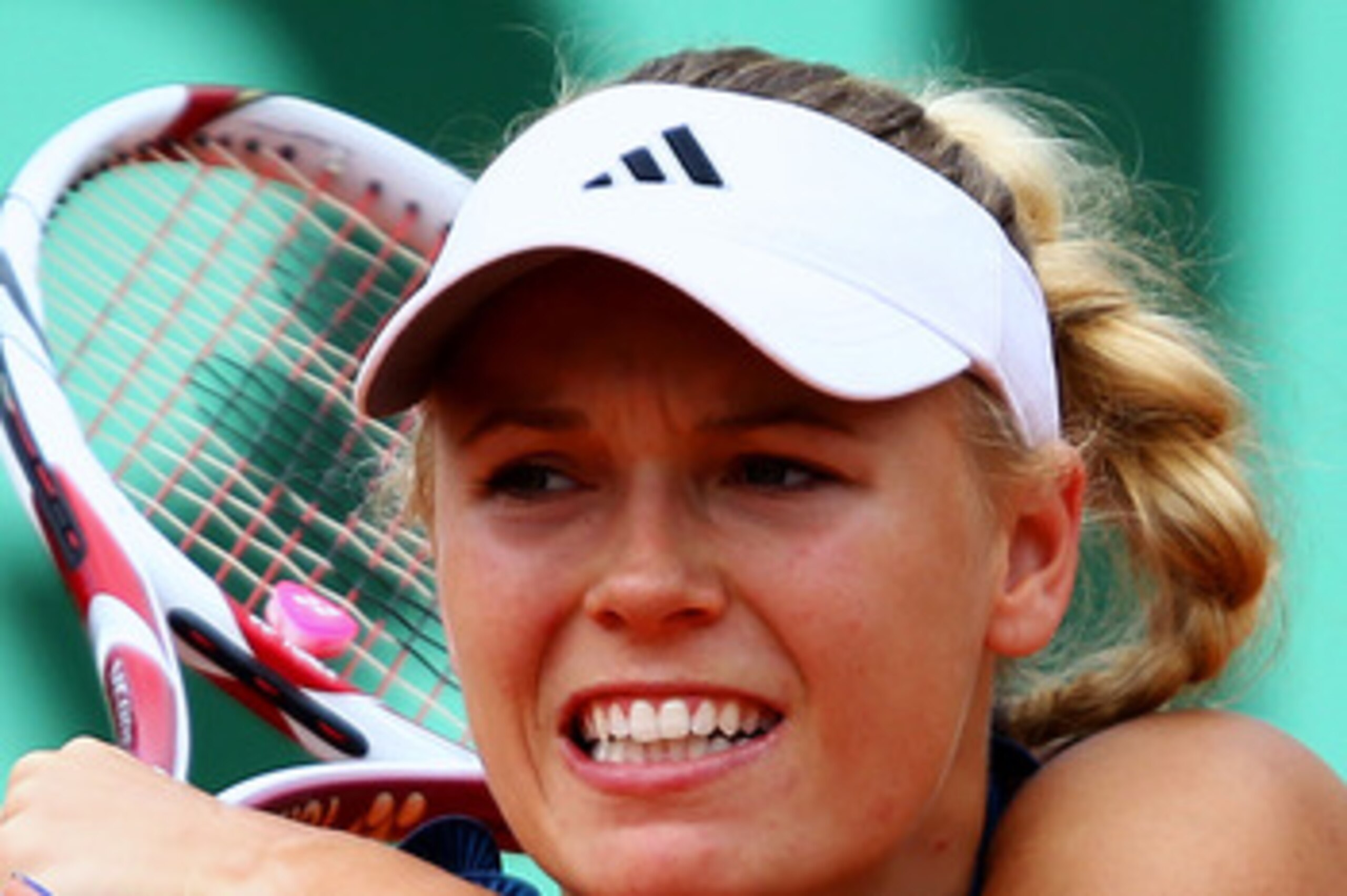 PARIS, FRANCE - MAY 27:  Caroline Wozniacki of Denmark hits a backhand during the women's singles round three match between Caroline Wozniacki of Denmark and Daniela Hantuchova of Slovakia on day six of the French Open at Roland Garros on May 27, 2011 in 