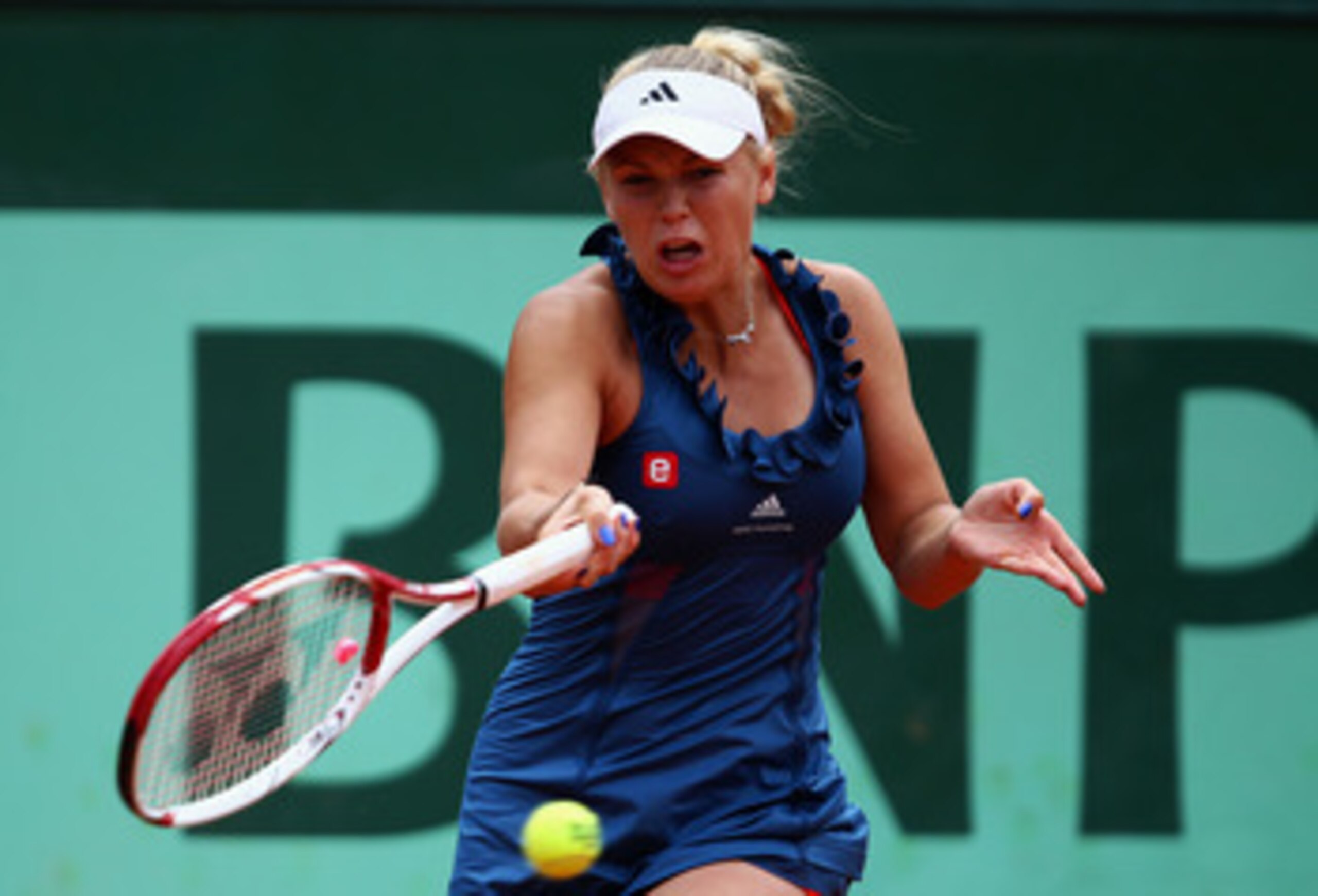 PARIS, FRANCE - MAY 27:  Caroline Wozniacki of Denmark hits a forehand during the women's singles round three match between Caroline Wozniacki of Denmark and Daniela Hantuchova of Slovakia on day six of the French Open at Roland Garros on May 27, 2011 in 