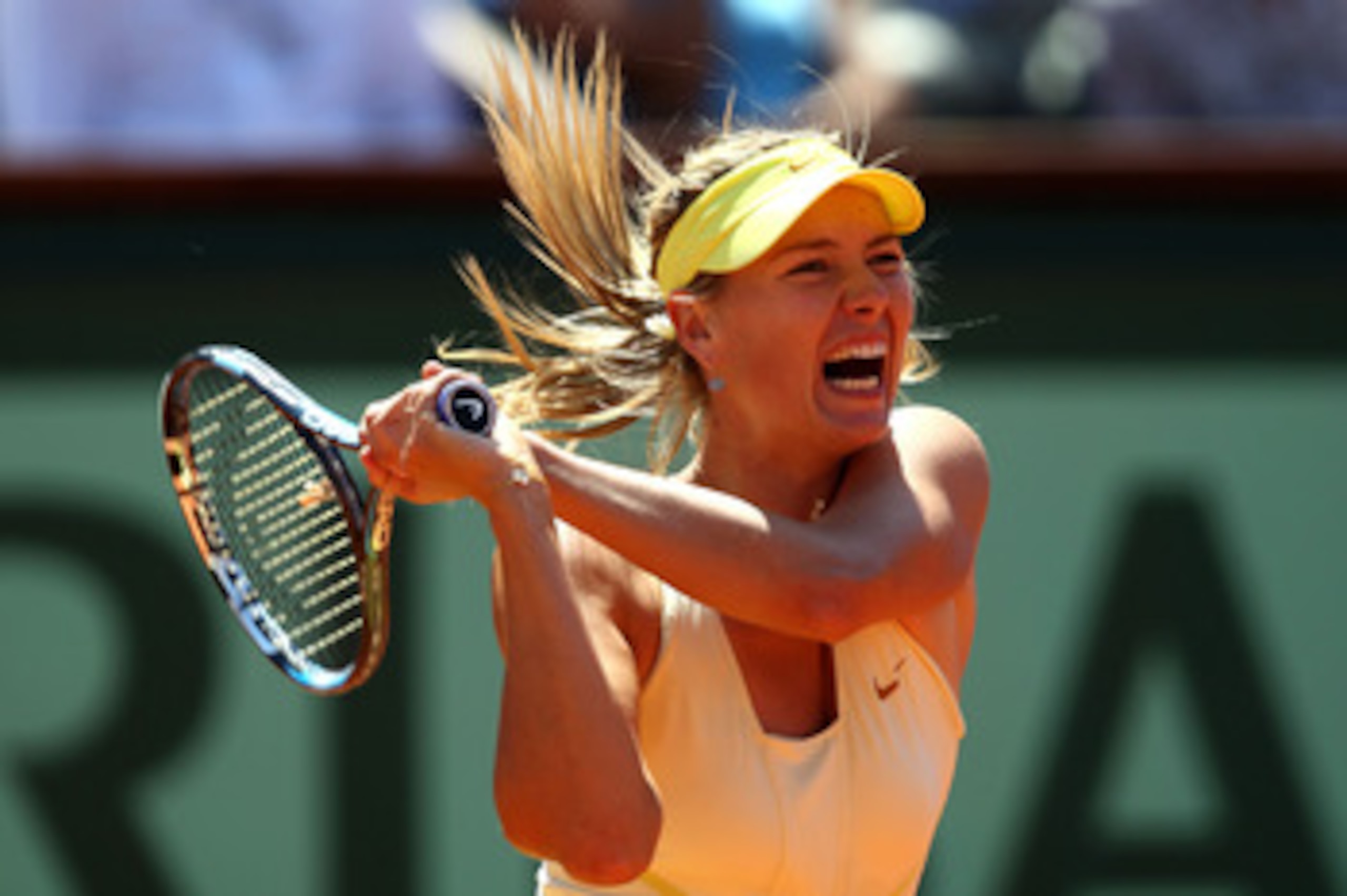 PARIS, FRANCE - JUNE 02:  Maria Sharapova of Russia hits a backhand during the women's singles semi final match between Na Li of China and Maria Sharapova of Russia on day twelve of the French Open at Roland Garros on June 2, 2011 in Paris, France.  (Phot