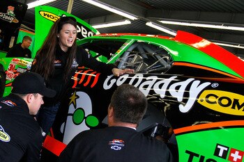 DAYTONA BEACH, FL - FEBRUARY 16:  Danica Patrick (C), driver of the #7 GoDaddy.com Chevrolet, talks with crew members in the garage prior to practice for the NASCAR Nationwide Series DRIVE4COPD 300 at Daytona International Speedway on February 16, 2011 in
