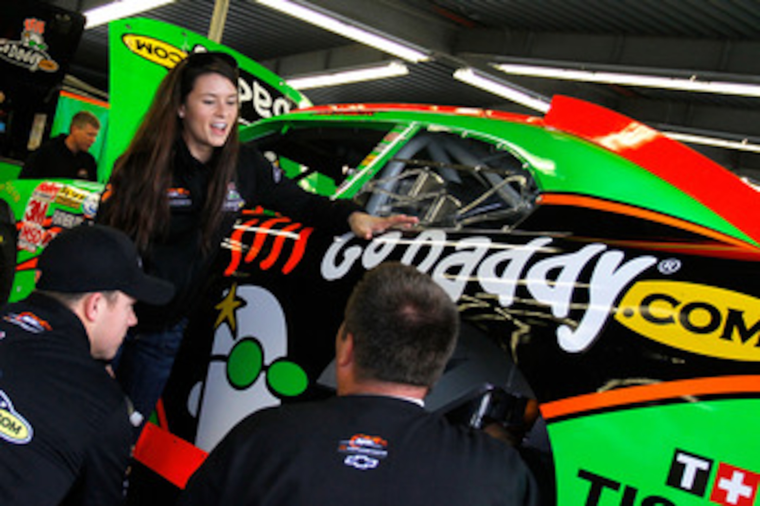 DAYTONA BEACH, FL - FEBRUARY 16: Danica Patrick (C), driver of the #7 GoDaddy.com Chevrolet, talks with crew members in the garage prior to practice for the NASCAR Nationwide Series DRIVE4COPD 300 at Daytona International Speedway on February 16, 2011 in DAYTONA BEACH, FL - FEBRUARY 16: Danica Patrick (C), driver of the #7 GoDaddy.com Chevrolet, talks with crew members in the garage prior to practice for the NASCAR Nationwide Series DRIVE4COPD 300 at Daytona International Speedway on February 16, 2011 in