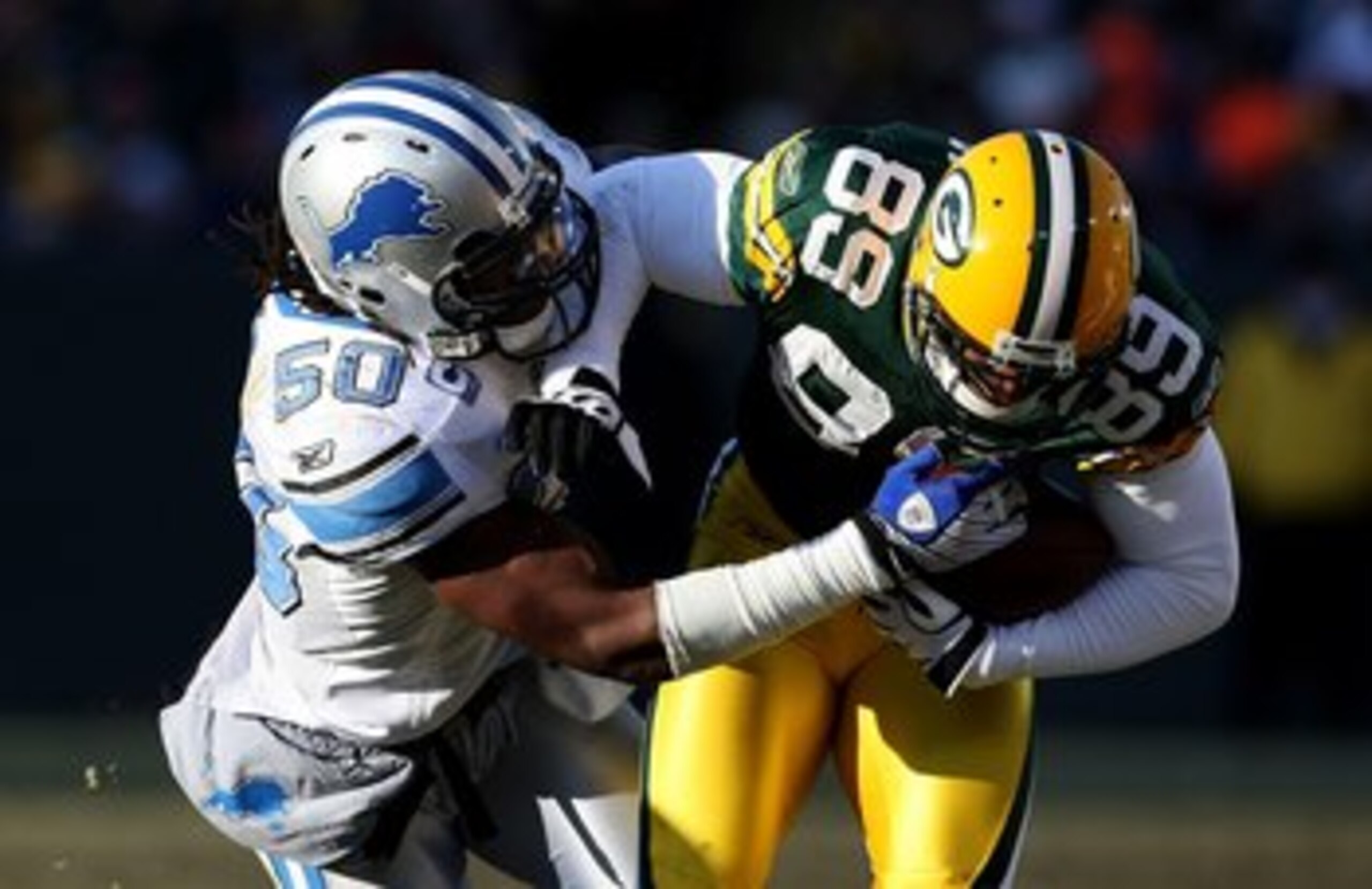 GREEN BAY, WI - DECEMBER 28: Ernie Sims #50 of the Detroit Lions brings down James Jones #89 of the Green Bay Packers on December 28, 2008 at Lambeau Field in Green Bay, Wisconsin. The Packers defeated the Lions 31-21. (Photo by Jonathan Daniel/Getty Imag