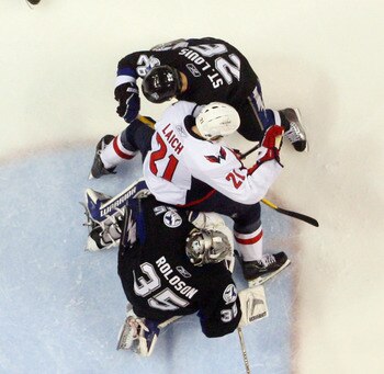 TAMPA, FL - MAY 03: Dwayne Roloson #35 and Martin St. Louis #26 of the Tampa Bay Lightning defend against Brooks Laich #21 of the Washington Capitals in Game Three of the Eastern Conference Semifinals during the 2011 NHL Stanley Cup Playoffs at St Pete Ti