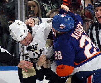 UNIONDALE, NY - APRIL 08:  Arron Asham #45 of the Pittsburgh Penguins fights with Zenon Konopka #28 of the New York Islanders in the first period at the Nassau Coliseum on April 8, 2011 in Uniondale, New York.  (Photo by Bruce Bennett/Getty Images)