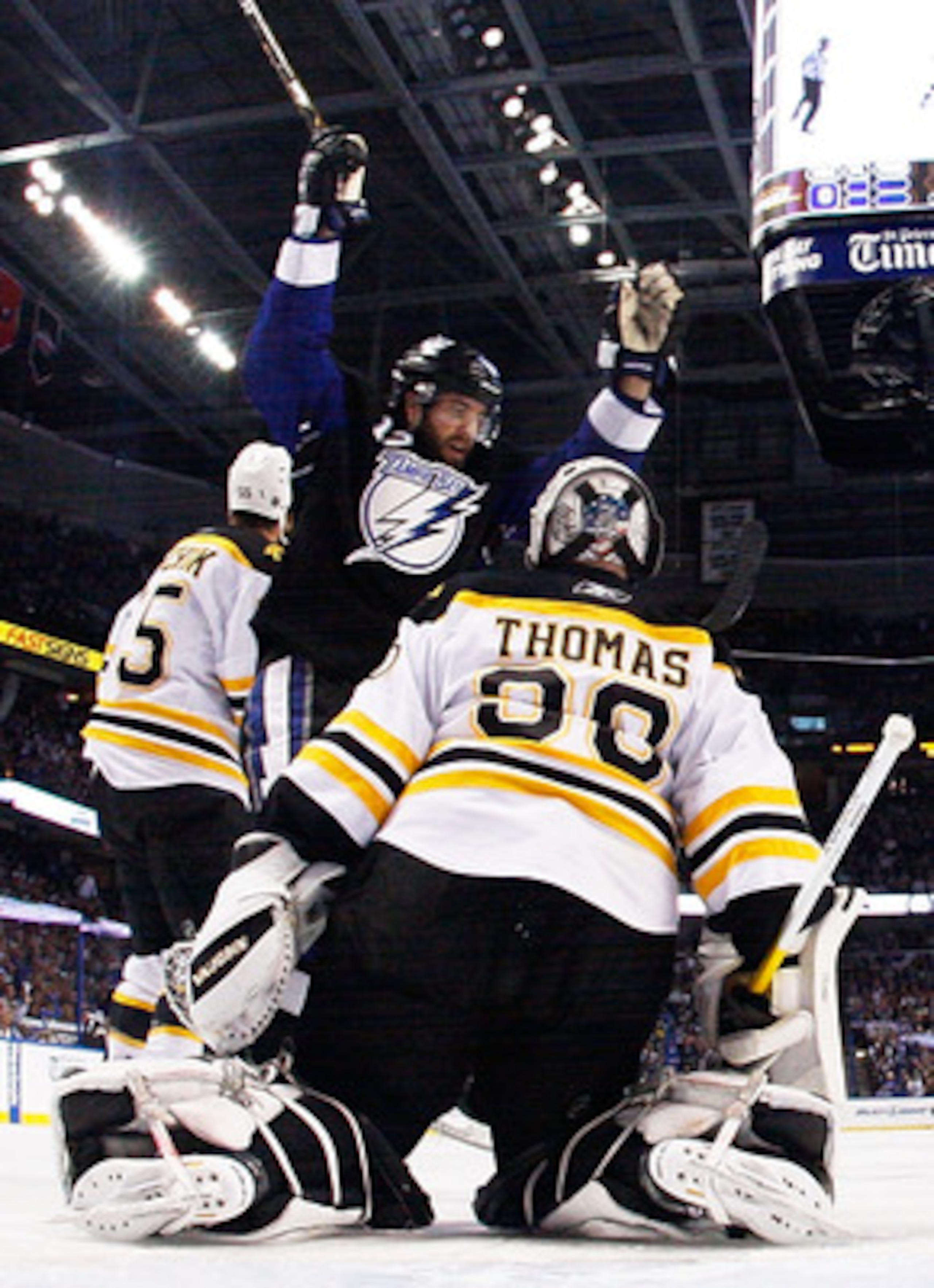 TAMPA, FL - MAY 25:  Simon Gagne #12 of the Tampa Bay Lightning celebrates a goal by Teddy Purcell #16 as Tim Thomas #30 of the Boston Bruins defends in Game Six of the Eastern Conference Finals during the 2011 NHL Stanley Cup Playoffs at St Pete Times Fo