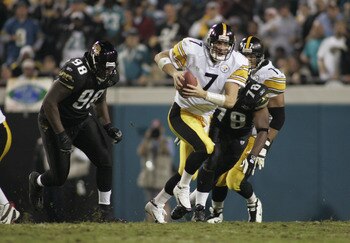JACKSONVILLE, FL - DECEMBER 5:  Quarterback Ben Roethlisberger #7 of the Pittsburgh Steelers scrambles against John Henderson #98 and Elton Patterson #78 of the Jacksonville Jaguars during the game at Alltel Stadium on December 5, 2004 in Jacksonville, Fl