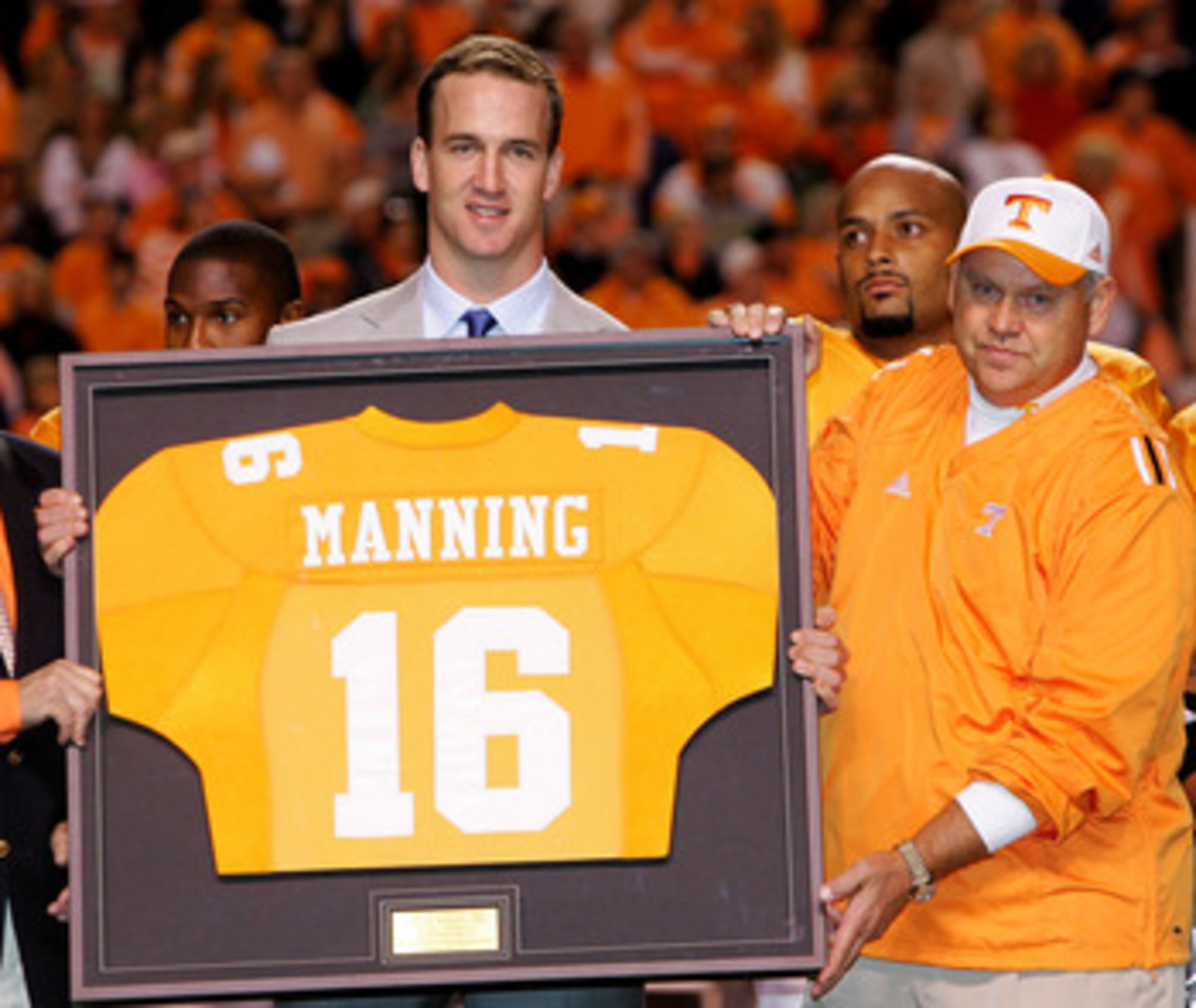 KNOXVILLE, TN - OCTOBER 29:  Former Tennesse quarterback Peyton Manning and current quarterback for the Indianapolis Colts is honored alongside his former college coach Phillip Fulmer before the start of the game against the South Carolina Gamecocks on Oc