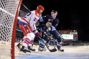 PITTSBURGH, PA - JANUARY 01: Mike Knuble #22 of the Washington Capitals looks for the puck as Paul Martin #7 of the Pittsburgh Penguins plays defense during the 2011 NHL Bridgestone Winter Classic at Heinz Field on January 1, 2011 in Pittsburgh, Pennsylva