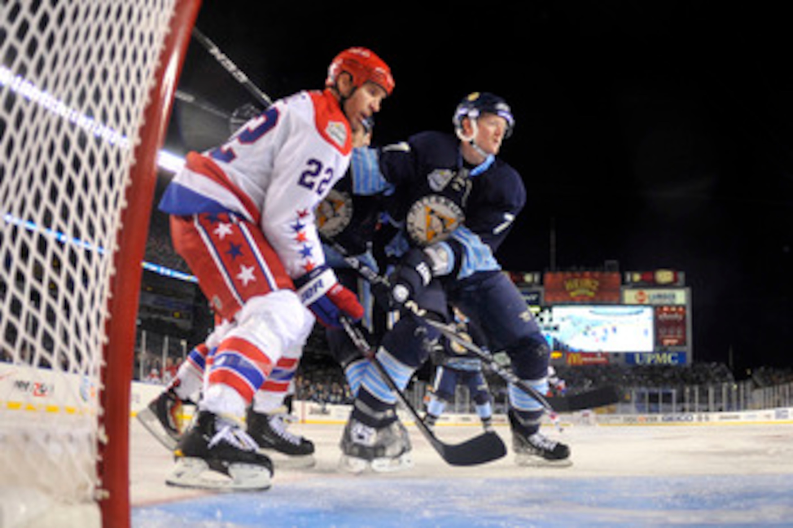 PITTSBURGH, PA - JANUARY 01: Mike Knuble #22 of the Washington Capitals looks for the puck as Paul Martin #7 of the Pittsburgh Penguins plays defense during the 2011 NHL Bridgestone Winter Classic at Heinz Field on January 1, 2011 in Pittsburgh, Pennsylva