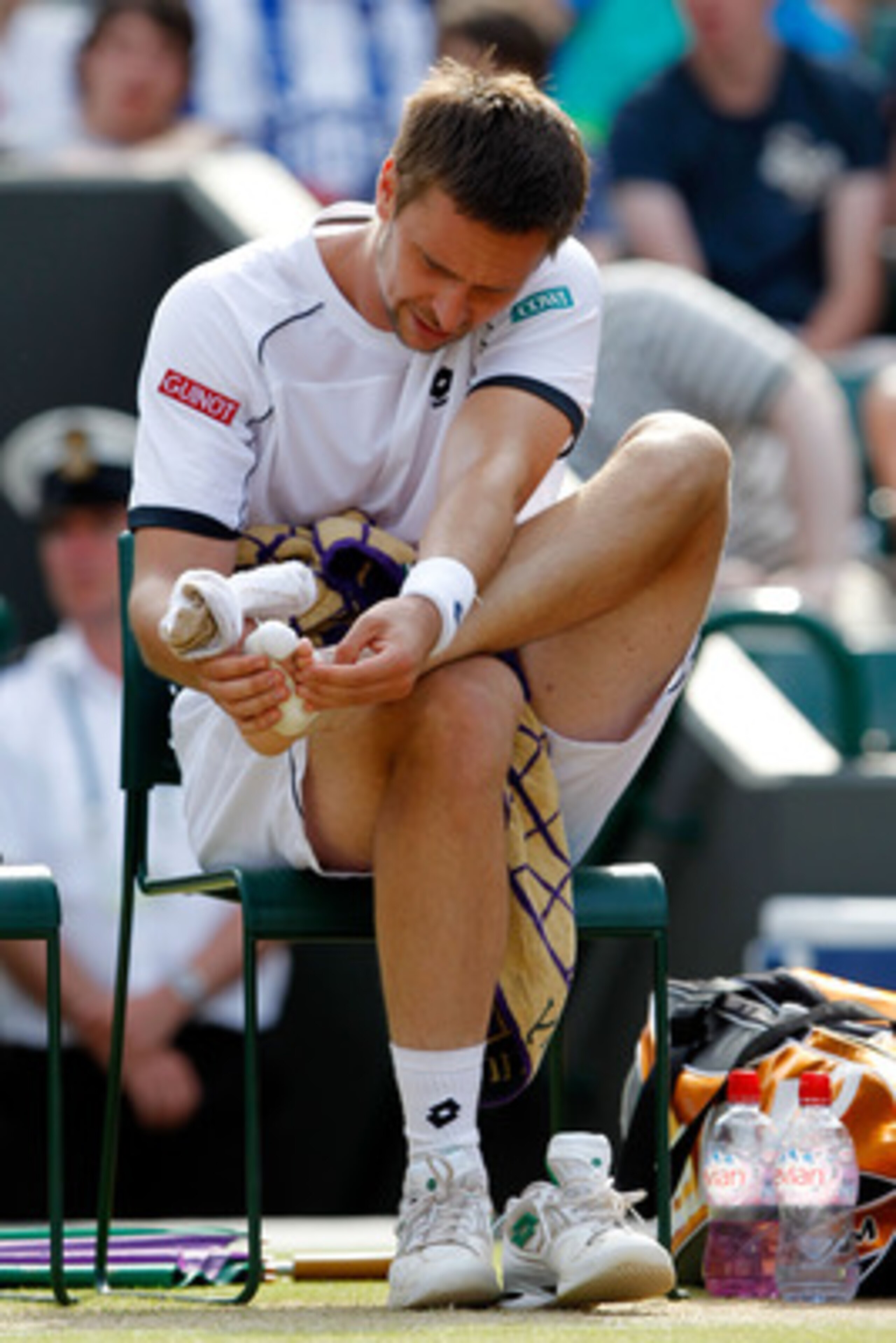 LONDON, ENGLAND - JUNE 30:  Robin Soderling of Sweden checks his foot between games during his Quarter Final match against Rafael Nadal of Spain on Day Nine of the Wimbledon Lawn Tennis Championships at the All England Lawn Tennis and Croquet Club on June