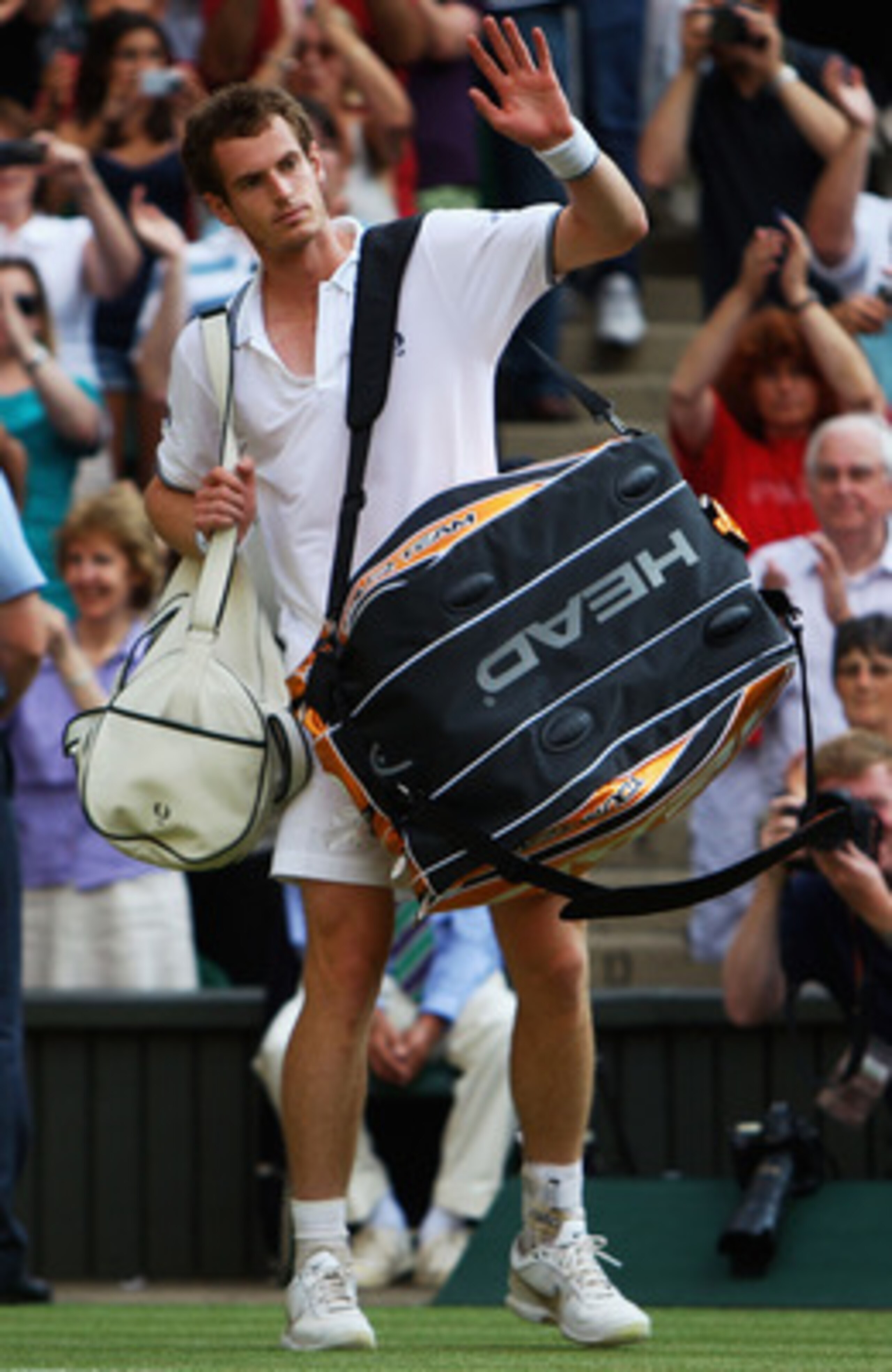 WIMBLEDON, ENGLAND - JULY 03:  Andy Murray of Great Britain waves to the crowd after defeat during the men's singles semi final match against Andy Roddick of USA on Day Eleven of the Wimbledon Lawn Tennis Championships at the All England Lawn Tennis and C