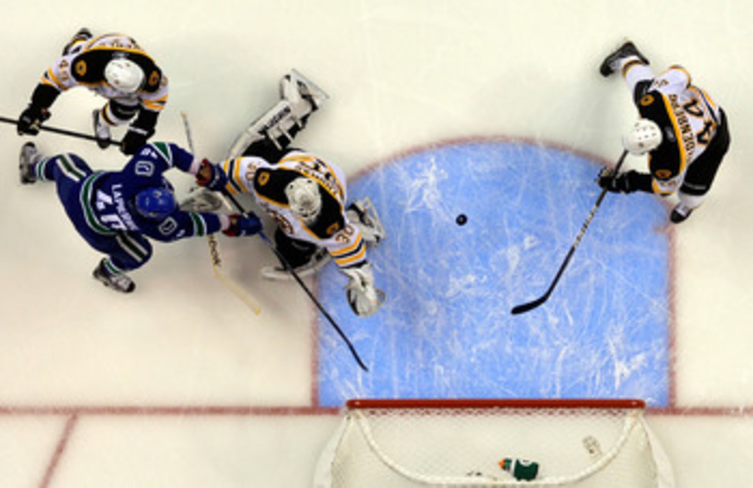 VANCOUVER, BC - JUNE 04:  Maxim Lapierre #40 of the Vancouver Canucks and Rich Peverley #49 of the Boston Bruins fight for the puck in front of Tim Thomas #30 of the Boston Bruins during Game Two of the 2011 NHL Stanley Cup Final at Rogers Arena on June 4