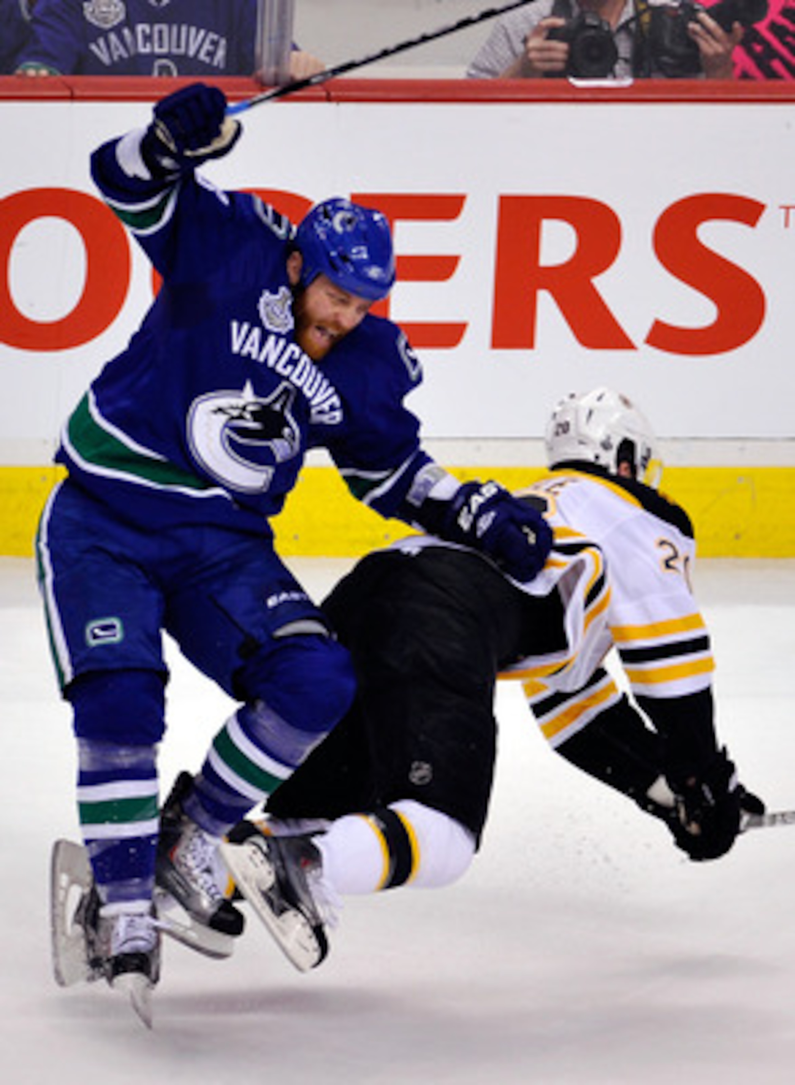 VANCOUVER, BC - JUNE 04:  Raffi Torres #13 of the Vancouver Canucks falls over Daniel Paille #20 of the Boston Bruins during Game Two of the 2011 NHL Stanley Cup Final at Rogers Arena on June 4, 2011 in Vancouver, British Columbia, Canada.  (Photo by Rich