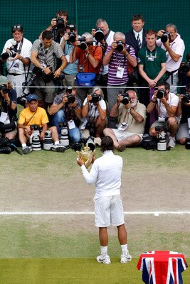 LONDON, ENGLAND - JULY 04:  Rafael Nadal of Spain holds the Championship trophy in front of the media after winning the Men's Singles Final match against Tomas Berdych of Czech Republic (R) on Day Thirteen of the Wimbledon Lawn Tennis Championships at the