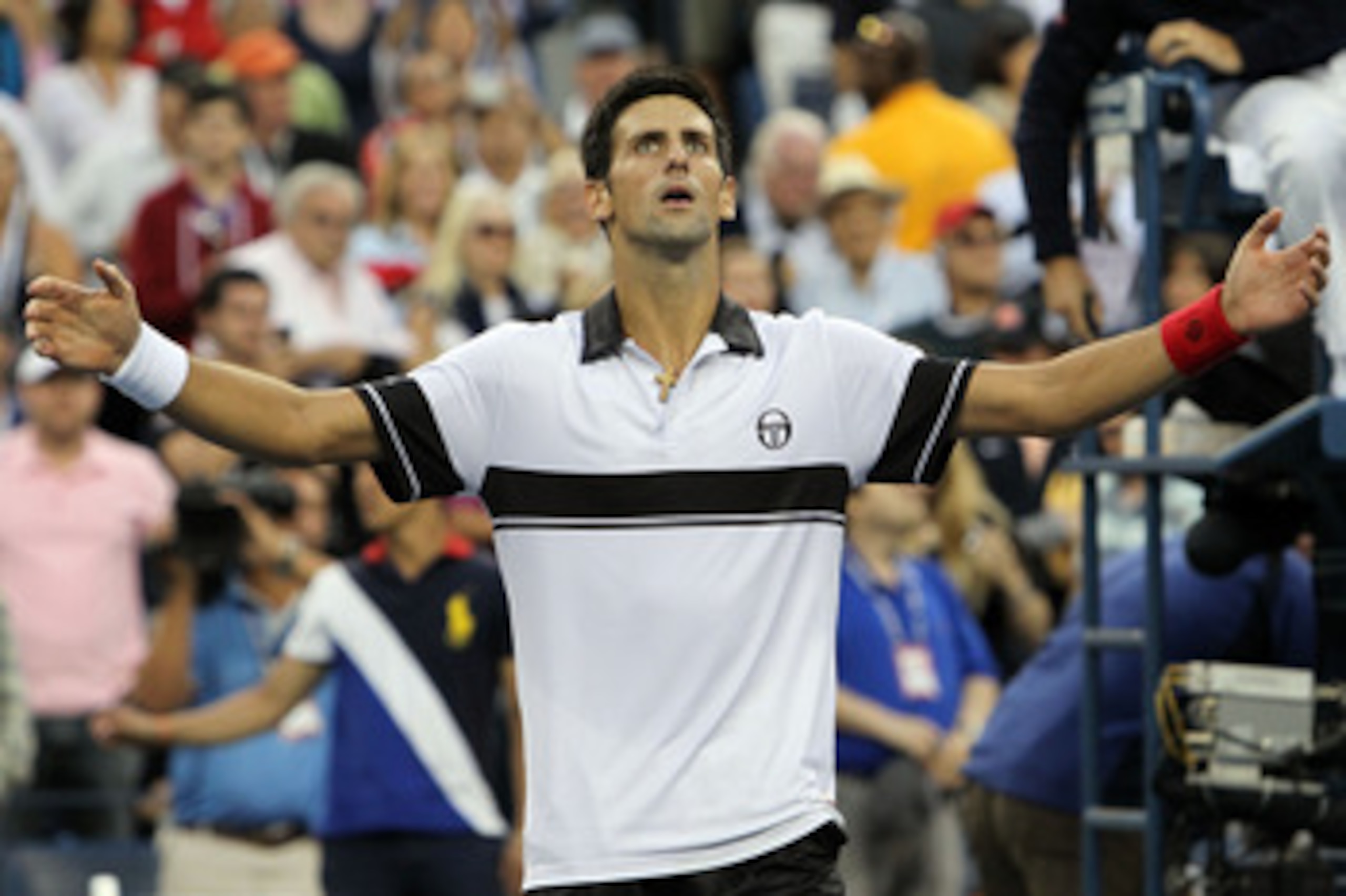 NEW YORK - SEPTEMBER 11: Novak Djokovic of Serbia celebrates defeating Roger Federer of Switzerland to win his men's singles semifinal match on day thirteen of the 2010 U.S. Open at the USTA Billie Jean King National Tennis Center on September 11, 2010 i NEW YORK - SEPTEMBER 11: Novak Djokovic of Serbia celebrates defeating Roger Federer of Switzerland to win his men's singles semifinal match on day thirteen of the 2010 U.S. Open at the USTA Billie Jean King National Tennis Center on September 11, 2010 i