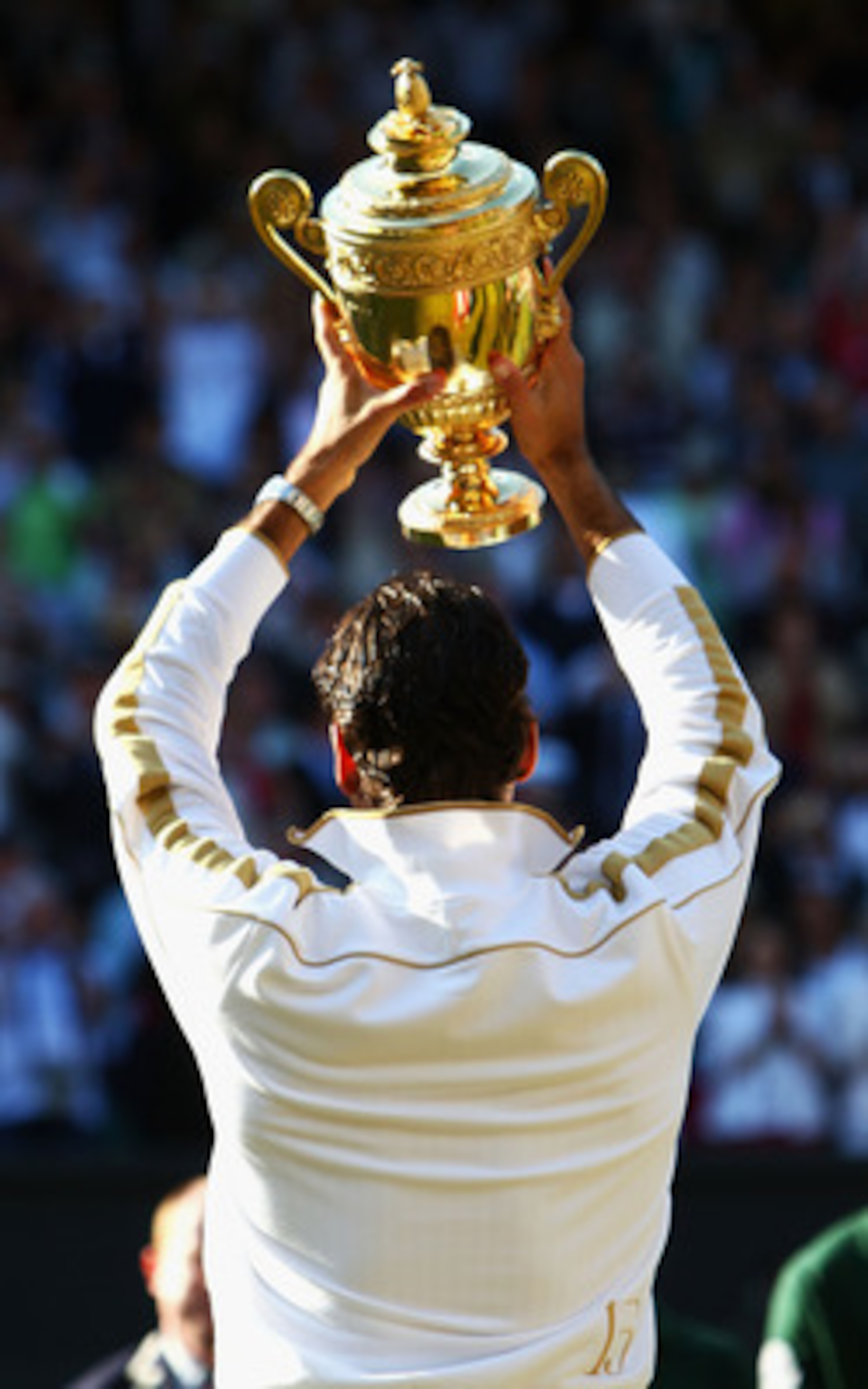 WIMBLEDON, ENGLAND - JULY 05:  Roger Federer of Switzerland celebrates victory with the trophy after the men's singles final match against Andy Roddick of USA on Day Thirteen of the Wimbledon Lawn Tennis Championships at the All England Lawn Tennis and Cr