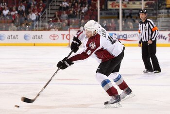 GLENDALE, AZ - APRIL 01:  John-Michael Liles #4 of the Colorado Avalanche passes the puck during the NHL game against the Phoenix Coyotes at Jobing.com Arena on April 1, 2011 in Glendale, Arizona.  The Avalanche defeated the Coyotes 4-3 in an overtime sho