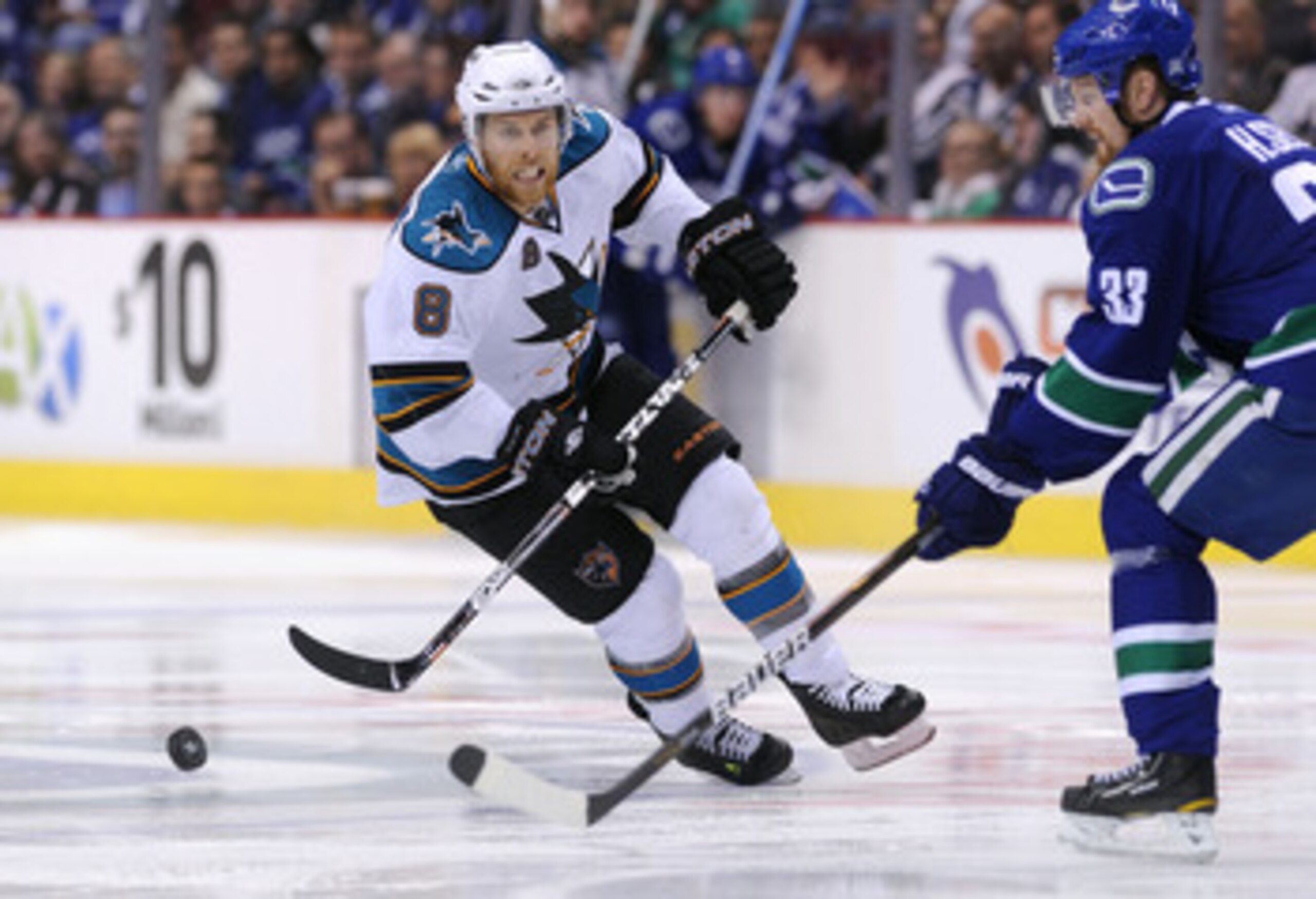 VANCOUVER, CANADA - MAY 24: Joe Pavelski #8 of the San Jose Sharks pursues the puck as Henrik Sedin #33 of the Vancouver Canucks tries to defend the play in the third period in Game Five of the Western Conference Finals during the 2011 Stanley Cup Playof VANCOUVER, CANADA - MAY 24: Joe Pavelski #8 of the San Jose Sharks pursues the puck as Henrik Sedin #33 of the Vancouver Canucks tries to defend the play in the third period in Game Five of the Western Conference Finals during the 2011 Stanley Cup Playof