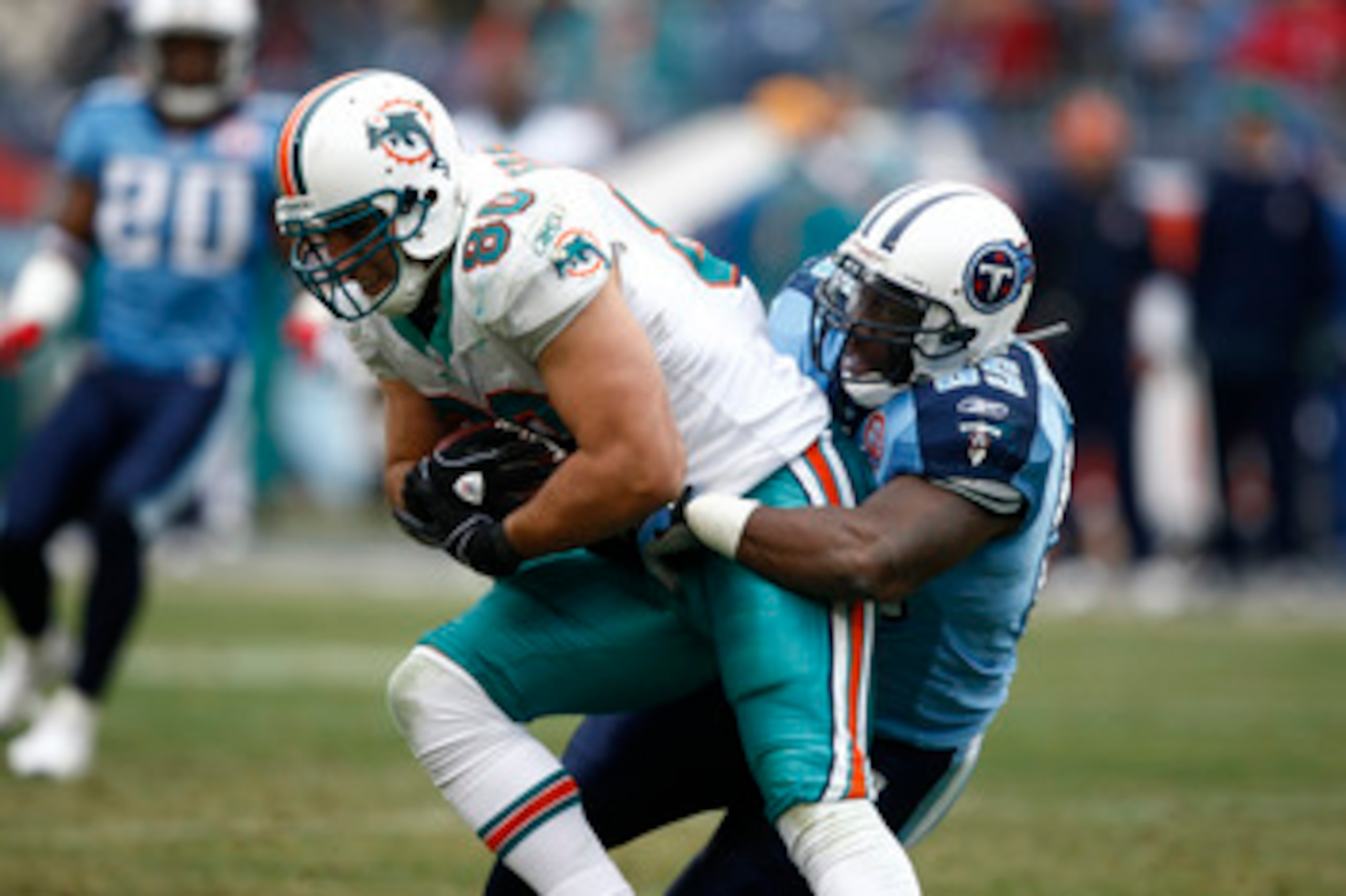 NASHVILLE, TN - DECEMBER 20: Stephen Tulloch #55 of the Tennessee Titans tackles Anthony Fasano #80 of the Miami Dolphins at LP Field on December 20, 2009 in Nashville, Tennessee. The Titans defeated the Dolphins 27-24 in overtime. (Photo by Joe Robbins/G