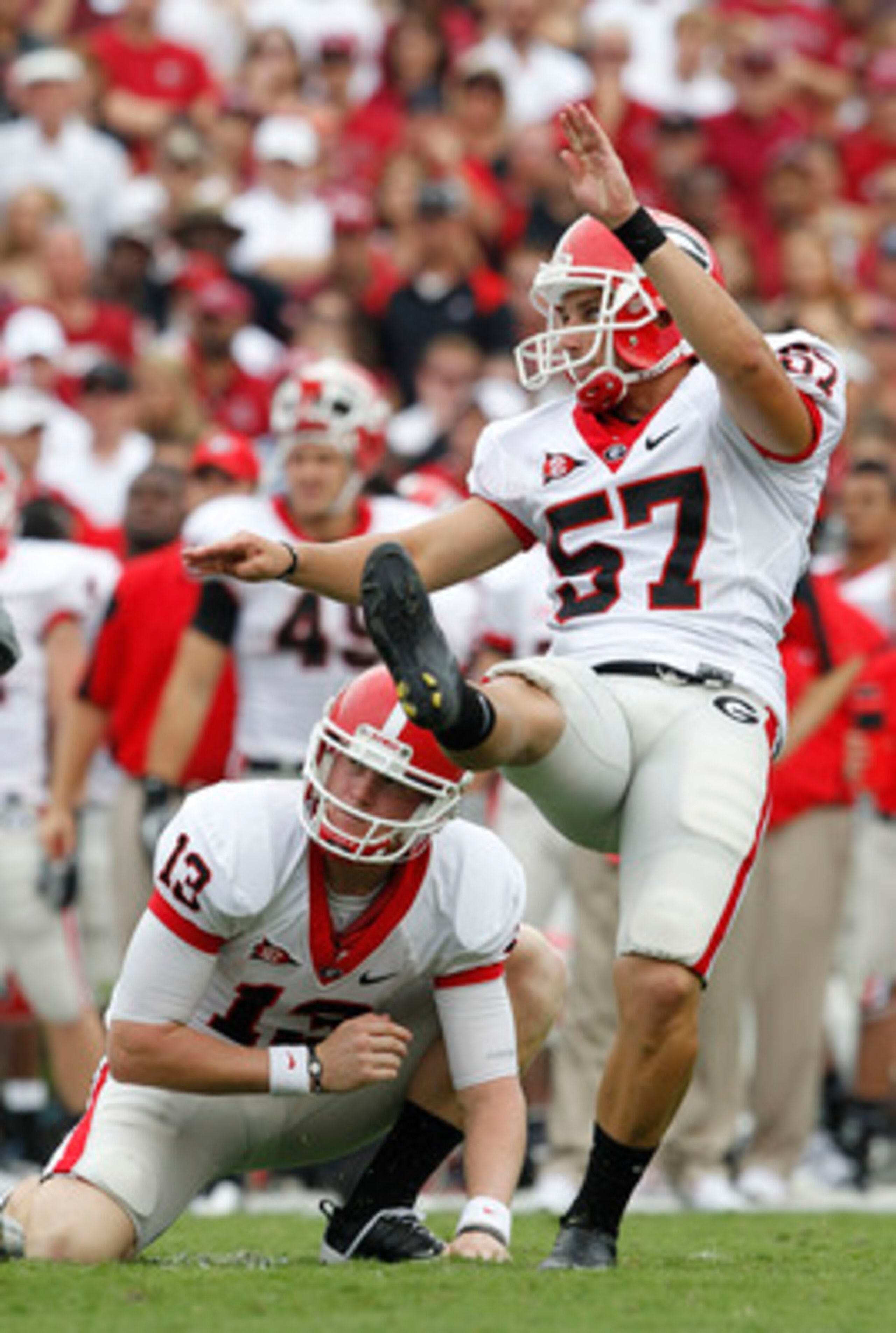 COLUMBIA, SC - SEPTEMBER 11:  Kicker Blair Walsh #57 of the Georgia Bulldogs follows through on a field goal attempt while holder Drew Butler #13 watches during the game against the South Carolina Gamecocks at Williams-Brice Stadium on September 11, 2010