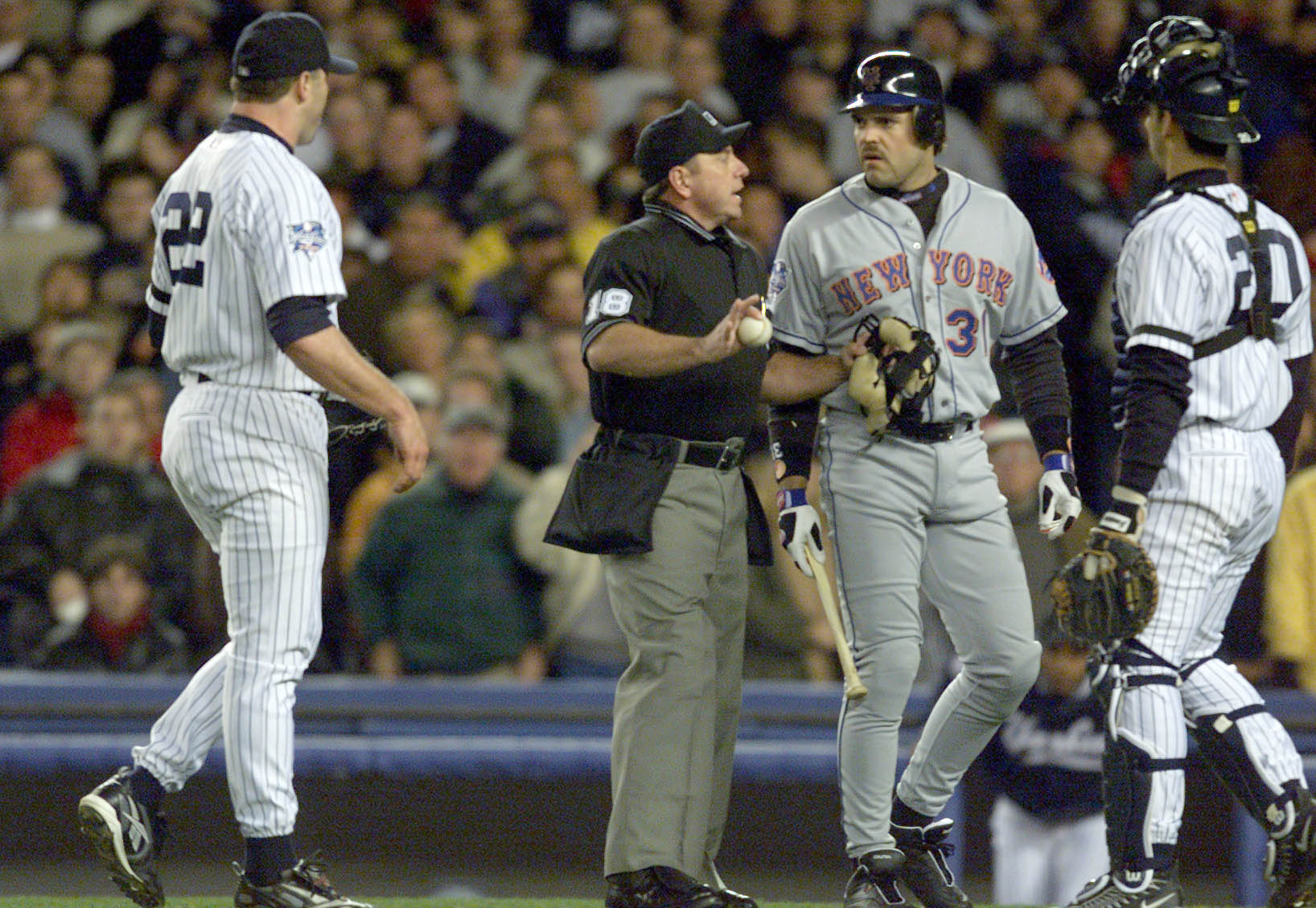 22 Oct 2000:   Mike Piazza of the New York Mets is restrained by home plate umpire Charlie Reliford from pitcher Roger Clemens after Clemens threw his broken bat in his direction in the first inning during Game 2 of the MLB World Series at Yankee Stadium