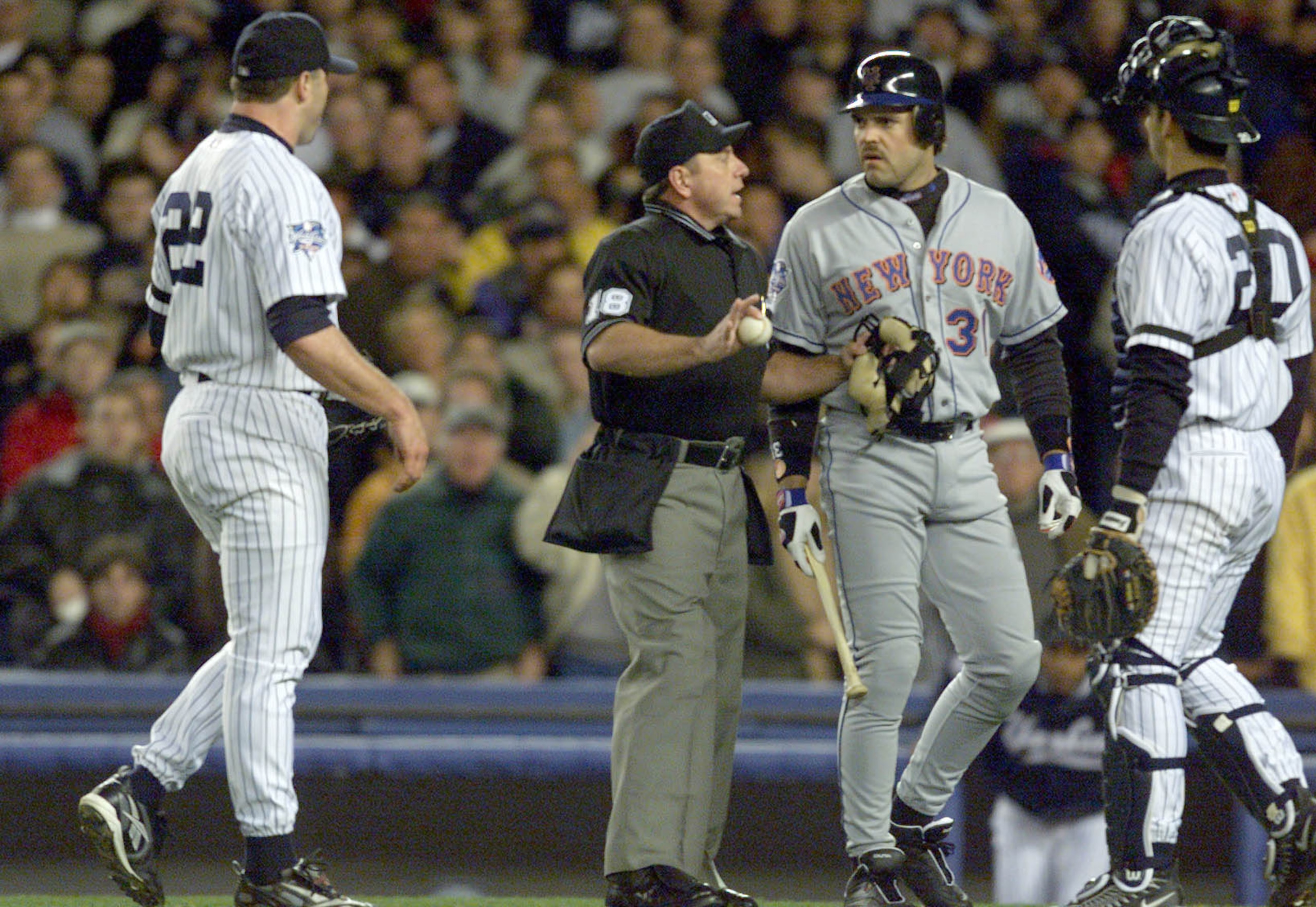 22 Oct 2000:   Mike Piazza of the New York Mets is restrained by home plate umpire Charlie Reliford from pitcher Roger Clemens after Clemens threw his broken bat in his direction in the first inning during Game 2 of the MLB World Series at Yankee Stadium