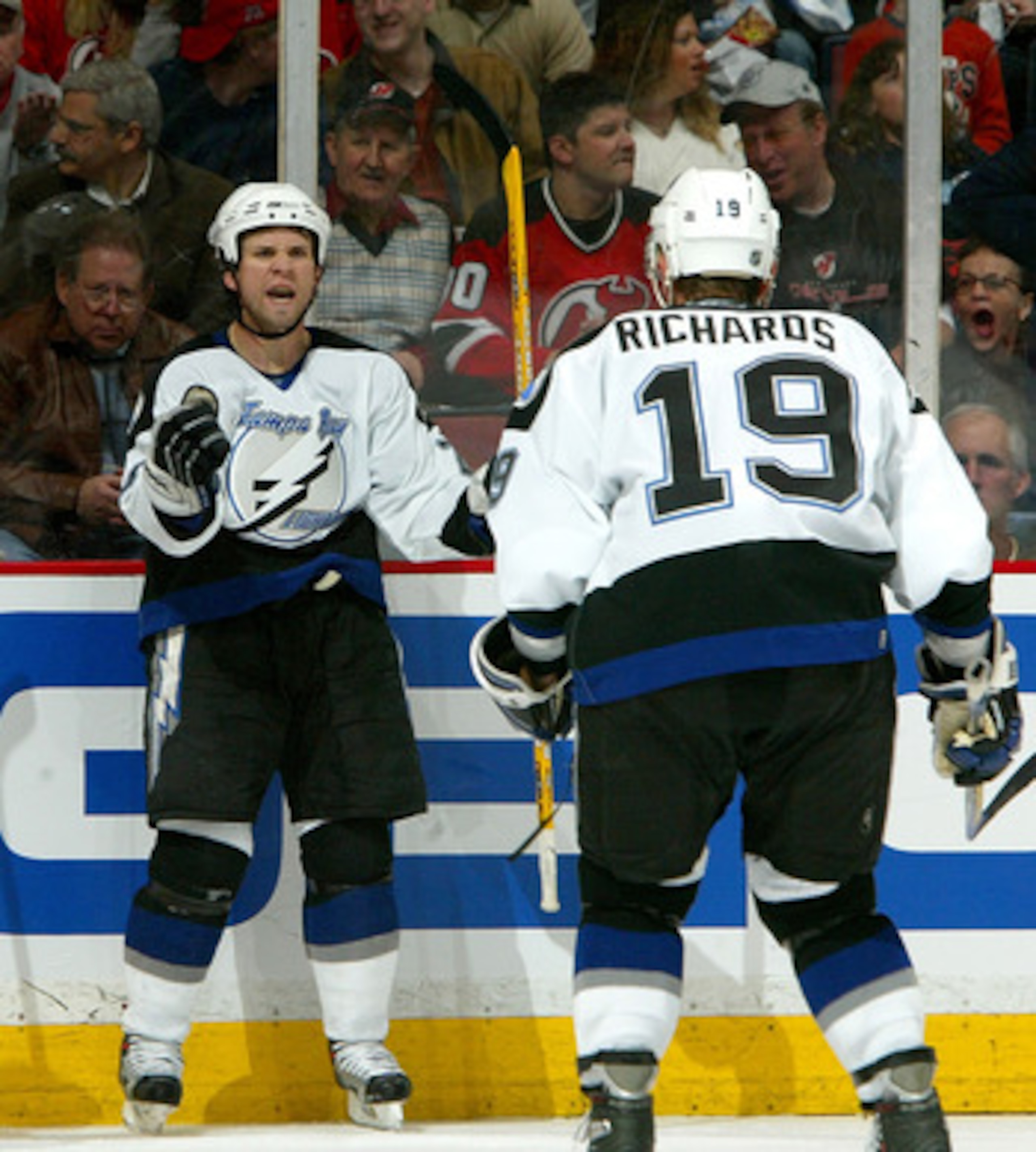EAST RUTHERFORD, NJ - APRIL 14:  Martin St. Louis #26 of the Tampa Bay Lightning celebrates his goal with teammate Brad Richards #19 as Scott Gomez #23 of the New Jersey Devils skates by during the second period of Game 2 of the 2007 Eastern Conference Qu