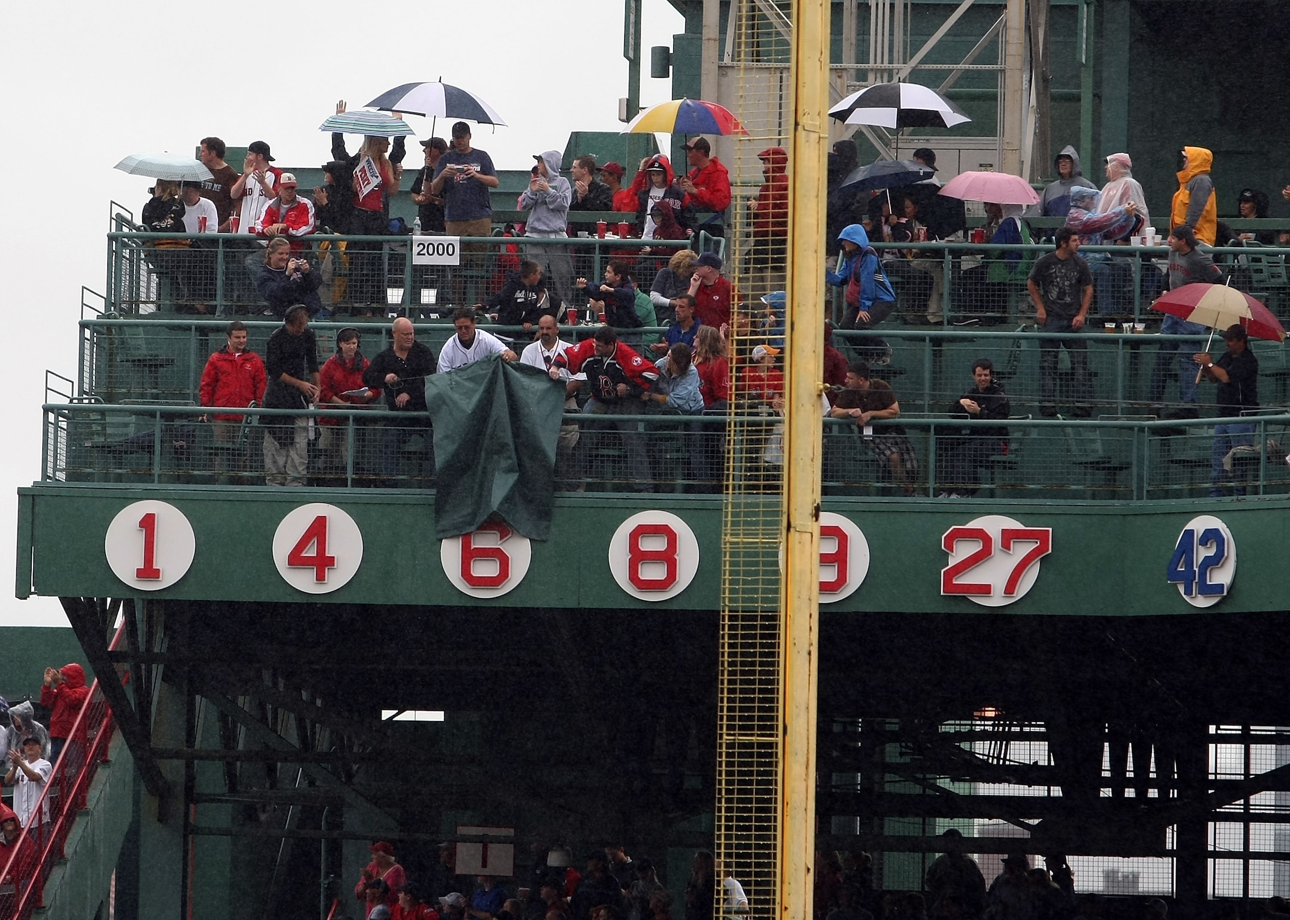 BOSTON - SEPTEMBER 28:  Former Boston Red Sox Carlton Fisk removes the banner covering up Johnny Pesky's number during the retirement ceremony before the game between the Boston Red Sox and the New York Yankees on September 28, 2008 during game one of the
