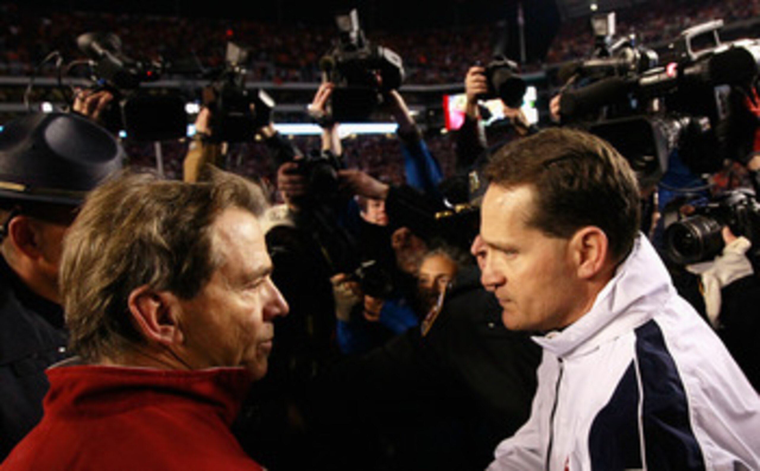 TUSCALOOSA, AL - NOVEMBER 26: Head coach Gene Chizik of the Auburn Tigers is congratulated by head coach Nick Saban of the Alabama Crimson Tide after the Tigers 28-27 win at Bryant-Denny Stadium on November 26, 2010 in Tuscaloosa, Alabama. (Photo by Kev TUSCALOOSA, AL - NOVEMBER 26: Head coach Gene Chizik of the Auburn Tigers is congratulated by head coach Nick Saban of the Alabama Crimson Tide after the Tigers 28-27 win at Bryant-Denny Stadium on November 26, 2010 in Tuscaloosa, Alabama. (Photo by Kev
