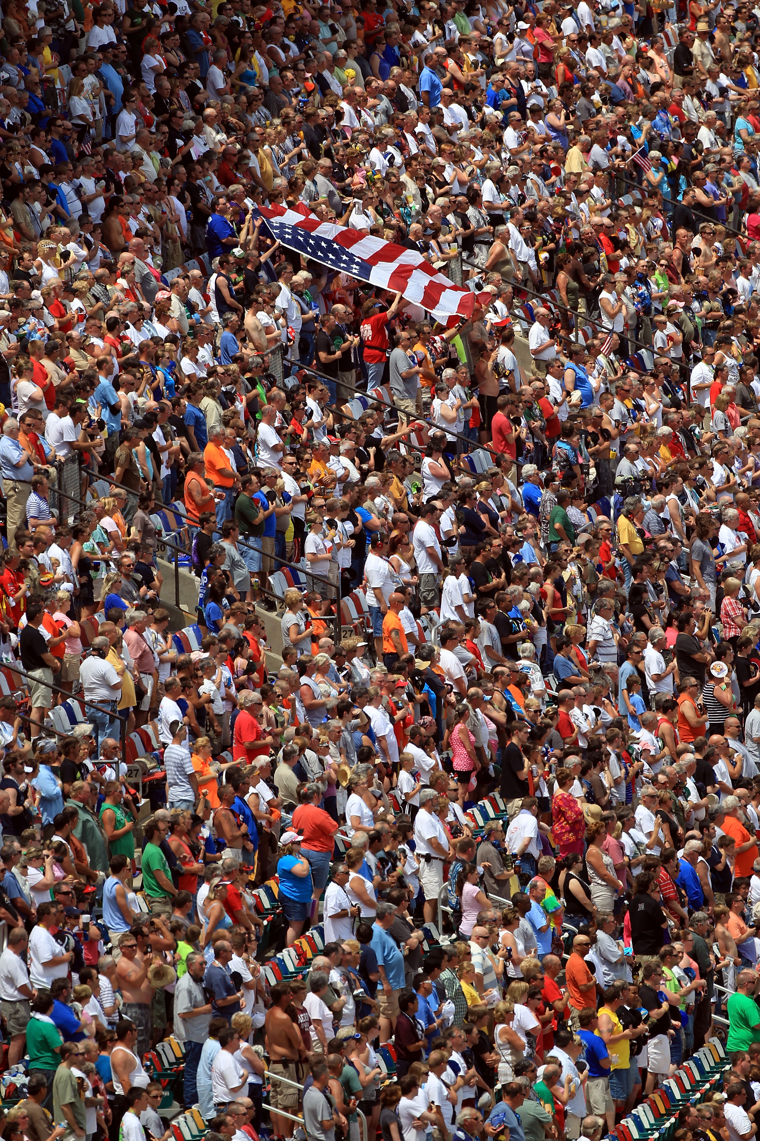 CHARLOTTE, NC - MAY 28:  Fans wave the American Flag in the grandstands prior to the NASCAR Nationwide Series Top Gear 300 at Charlotte Motor Speedway on May 28, 2011 in Charlotte, North Carolina.  (Photo by Streeter Lecka/Getty Images)