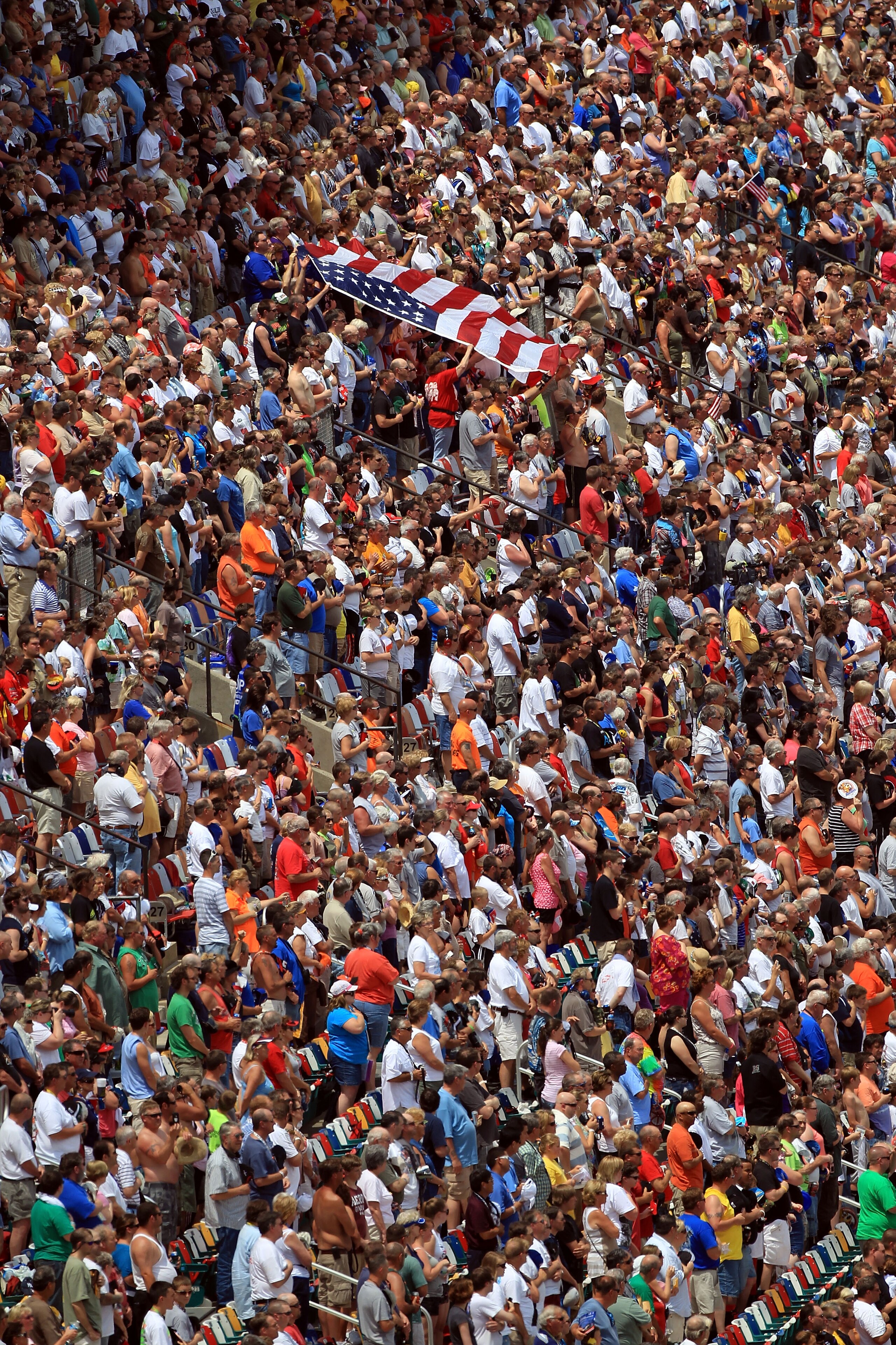 CHARLOTTE, NC - MAY 28:  Fans wave the American Flag in the grandstands prior to the NASCAR Nationwide Series Top Gear 300 at Charlotte Motor Speedway on May 28, 2011 in Charlotte, North Carolina.  (Photo by Streeter Lecka/Getty Images)