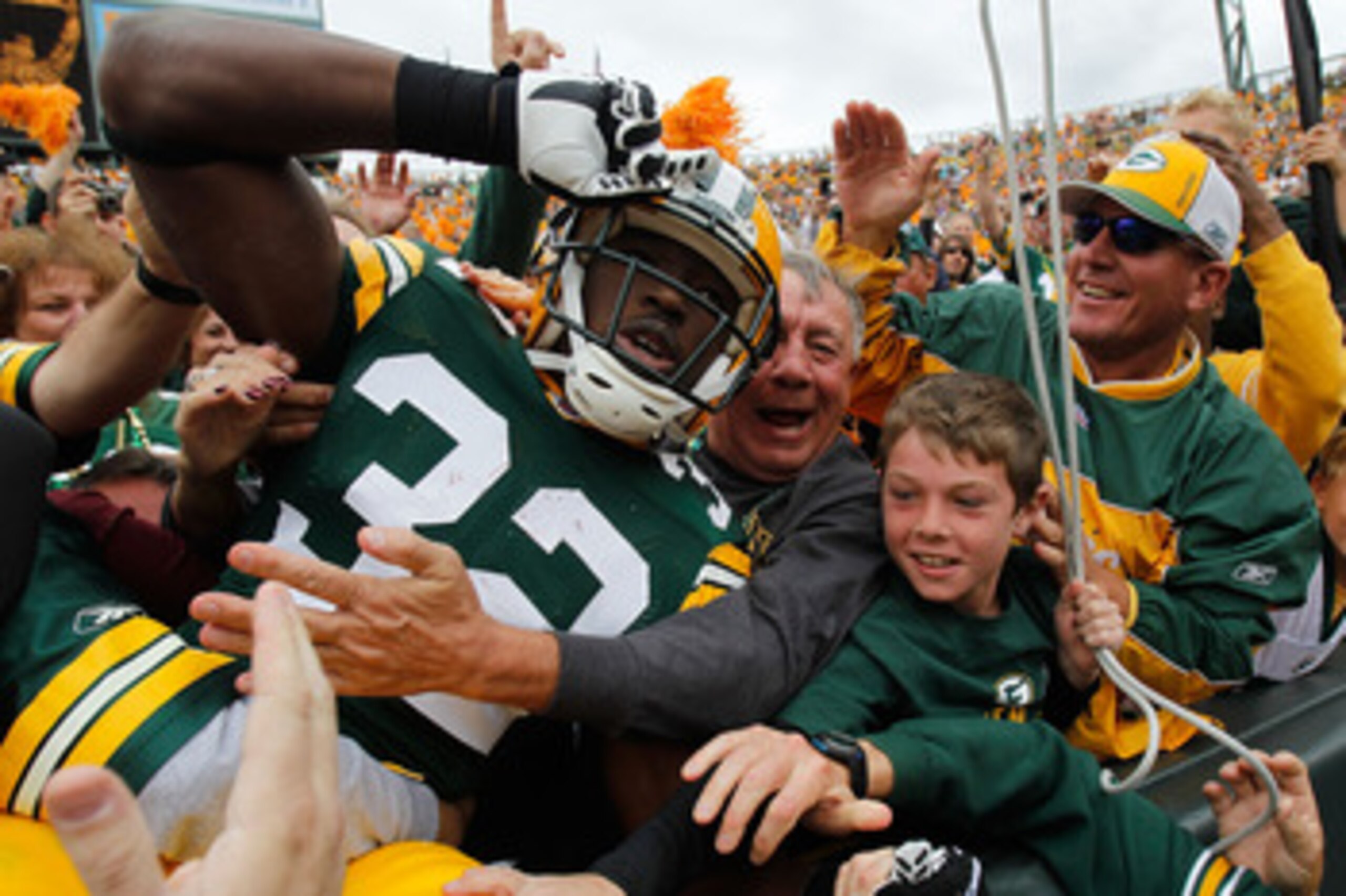 GREEN BAY, WI - SEPTEMBER 19: Brandon Jackson #32 of the Green Bay Packers celebrates a touchdown with a 'Lambeau Leap' into the stands against of the Buffalo Bills at Lambeau Field on September 19, 2010 in Green Bay, Wisconsin. The Packers defeated the B