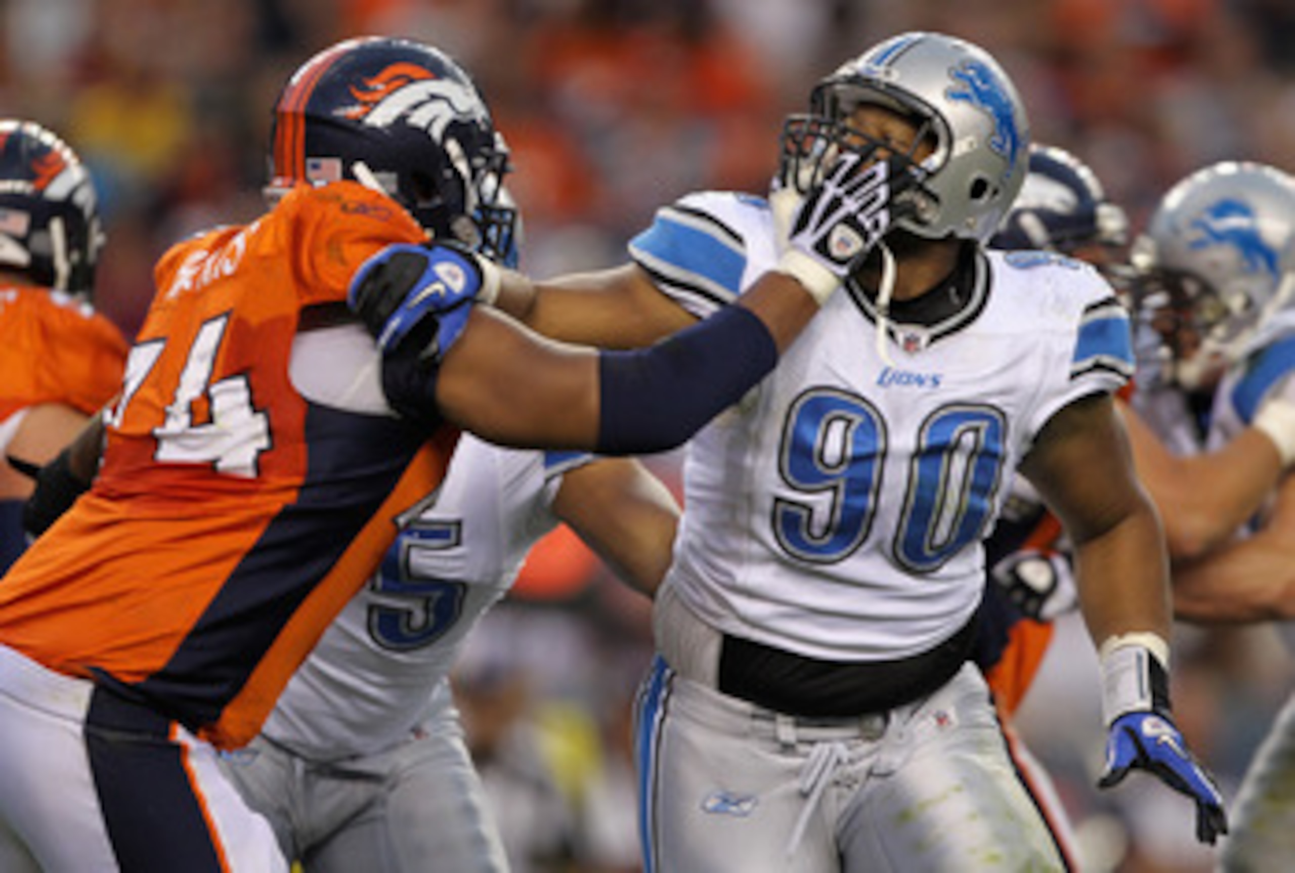 DENVER - AUGUST 21:  Defensive tackle Ndamukong Suh #90 of the Detroit Lions battles the blocking of offensive tackle Ryan Harris #74 of the Denver Broncos during preseason NFL action at INVESCO Field at Mile High on August 21, 2010 in Denver, Colorado.