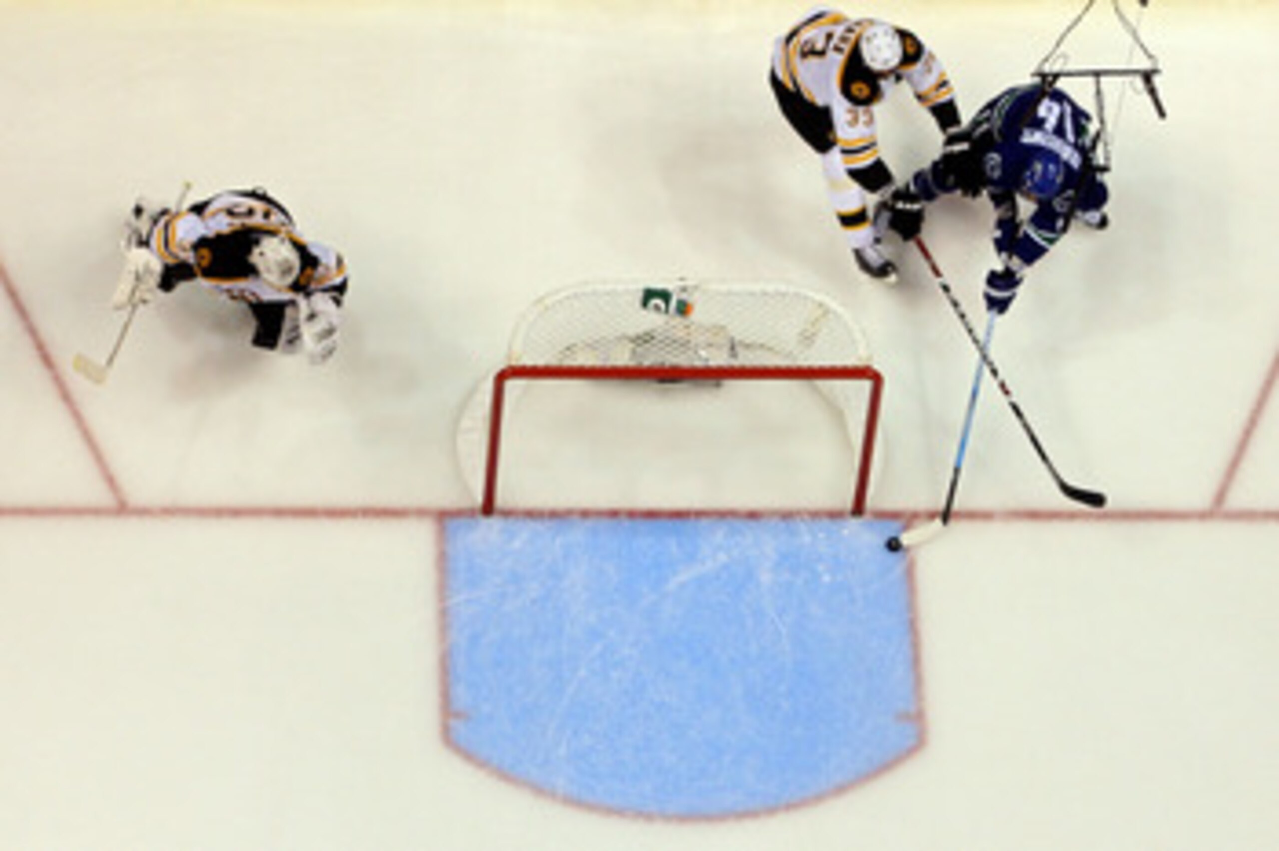 VANCOUVER, BC - JUNE 04:  Alex Burrows #14 of the Vancouver Canucks scores a goal in overtime against Zdeno Chara #33 and Tim Thomas #30 of the Boston Bruins to win Game Two of the 2011 NHL Stanley Cup Final at Rogers Arena on June 4, 2011 in Vancouver, B
