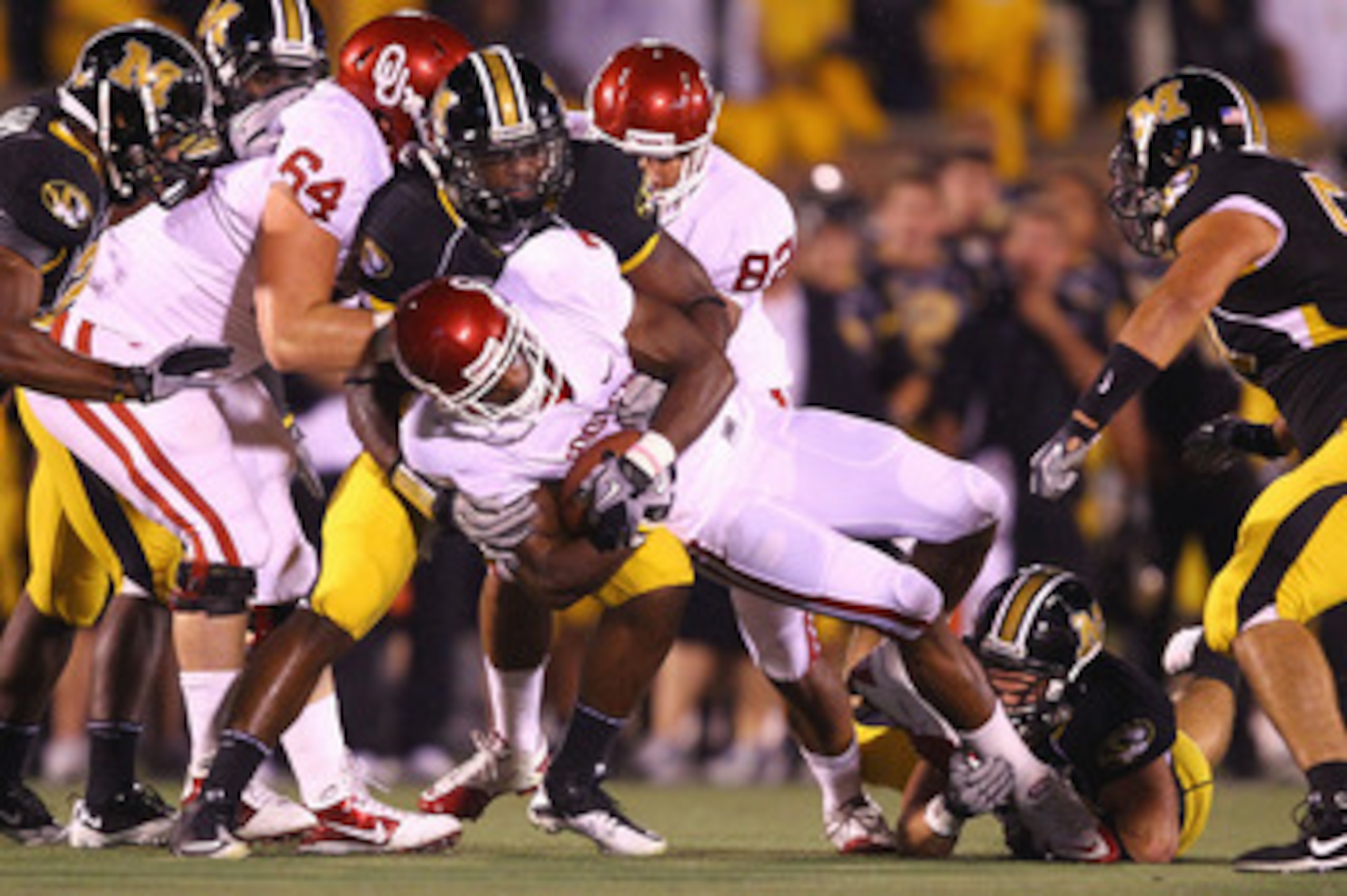 COLUMBIA, MO - OCTOBER 23: DeMarco Murray #7 of the Oklahoma Sooners is tackled by Jacquies Smith #3 of the Missouri Tigers at Faurot Field/Memorial Stadium on October 23, 2010 in Columbia, Missouri.  (Photo by Dilip Vishwanat/Getty Images)