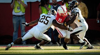 LINCOLN, NE - OCTOBER 30: Running back Rex Burkhead #22 of the Nebraska Cornhuskers fights for yardage between linebacker Zaviar Gooden #25 and defensive back Carl Gettis #19 of the Missouri Tigers during second half action of their game at Memorial Stadi