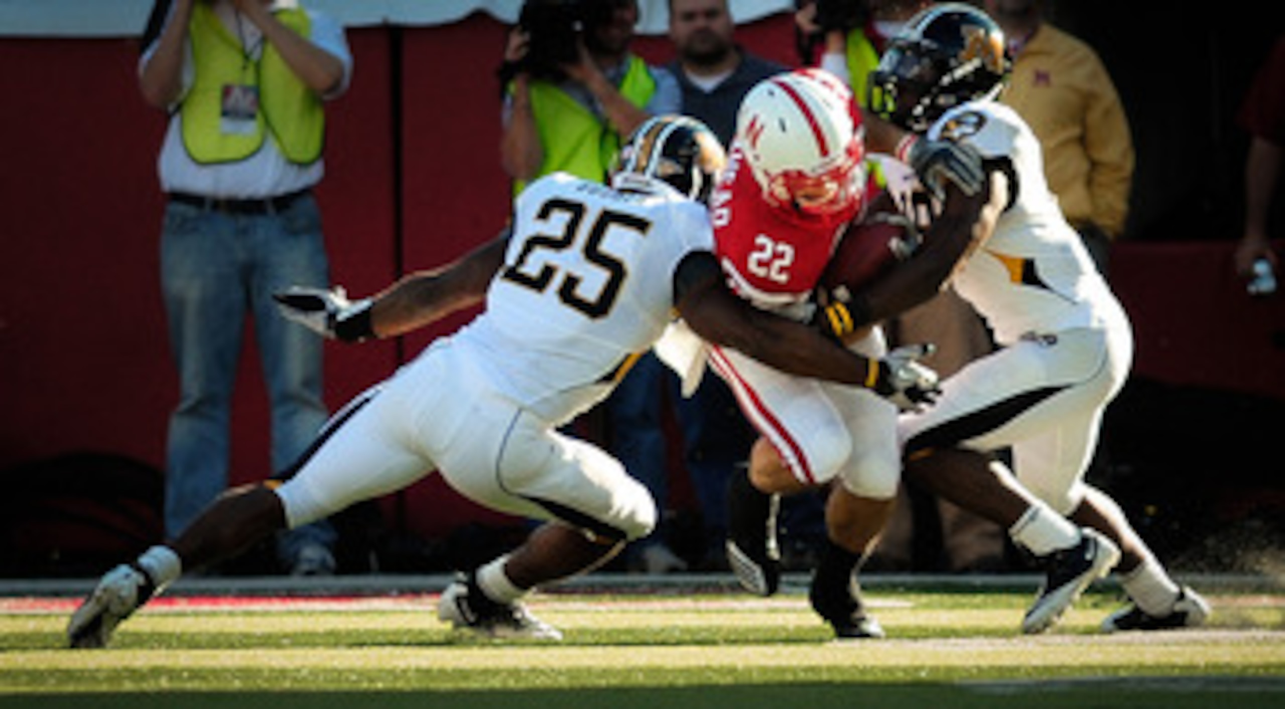LINCOLN, NE - OCTOBER 30: Running back Rex Burkhead #22 of the Nebraska Cornhuskers fights for yardage between linebacker Zaviar Gooden #25 and defensive back Carl Gettis #19 of the Missouri Tigers during second half action of their game at Memorial Stadi