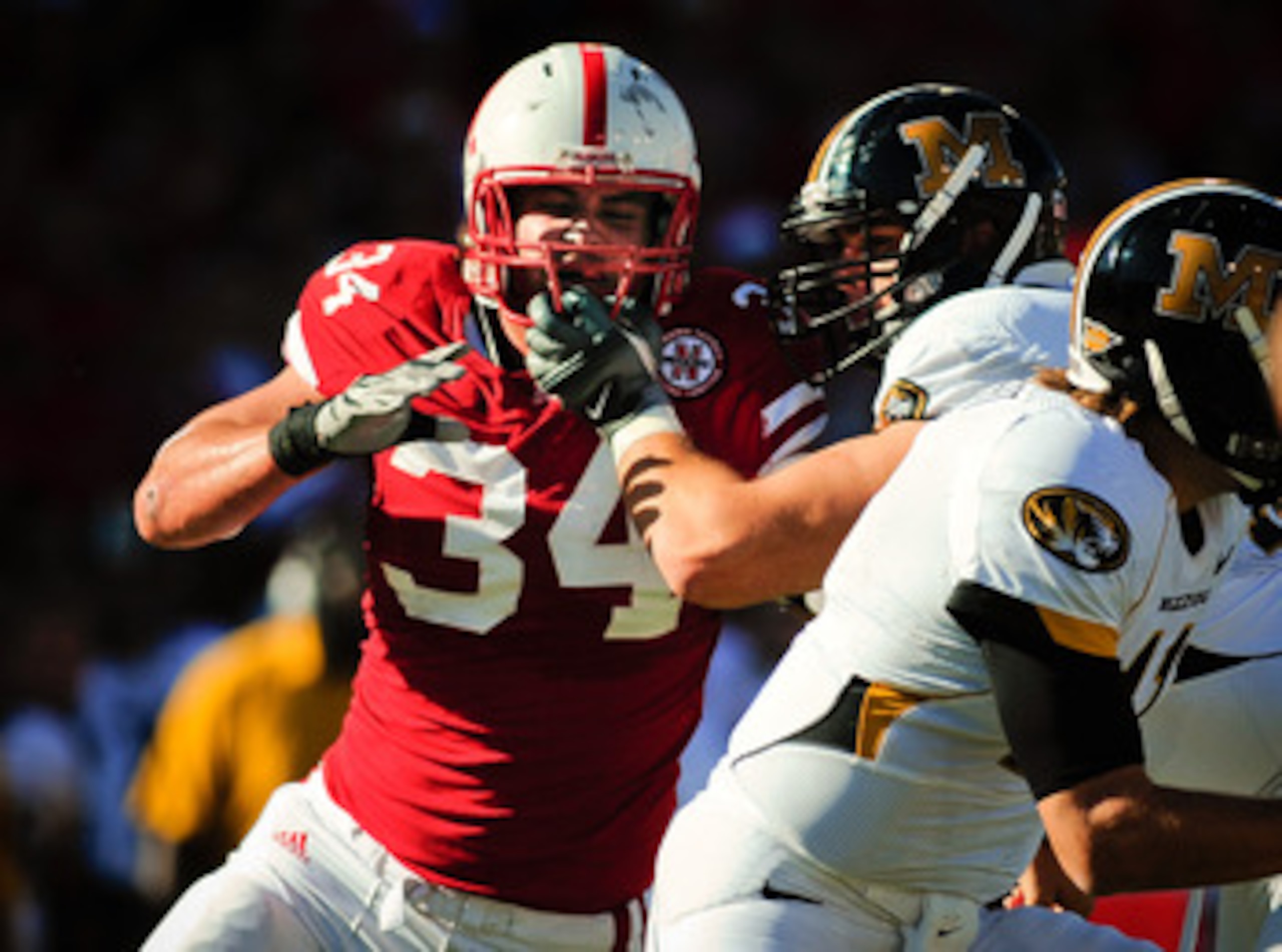 LINCOLN, NE - OCTOBER 30: Defensive end Cameron Meredith #34 of the Nebraska Cornhuskers  tries to beat offensive linesman Elvis Fisher #72 of the Missouri Tigers during first half action of their game at Memorial Stadium on October 30, 2010 in Lincoln, N
