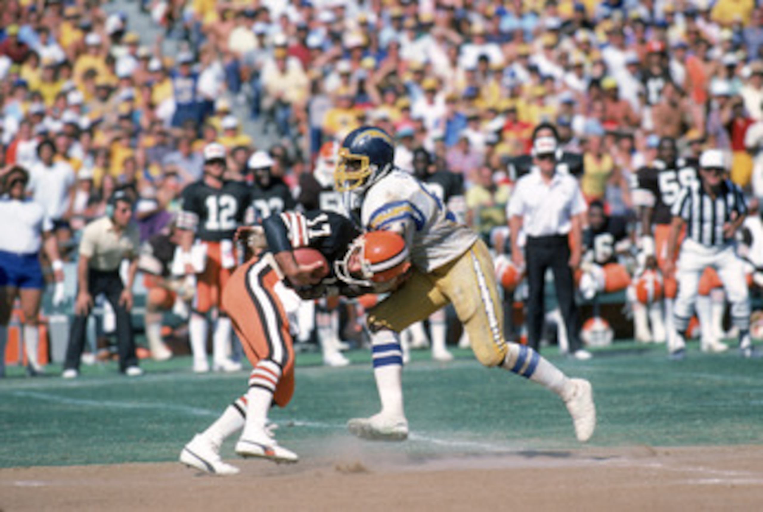 SAN DIEGO - SEPTEMBER 25:  Linebacker Woodrow Lowe #51 of the San Diego Chargers sacks quarterback Brian Sipe #17 of the Cleveland Browns during a game at Jack Murphy Stadium on September 25, 1983 in San Diego, California.  The Browns won 30-24.  (Photo b