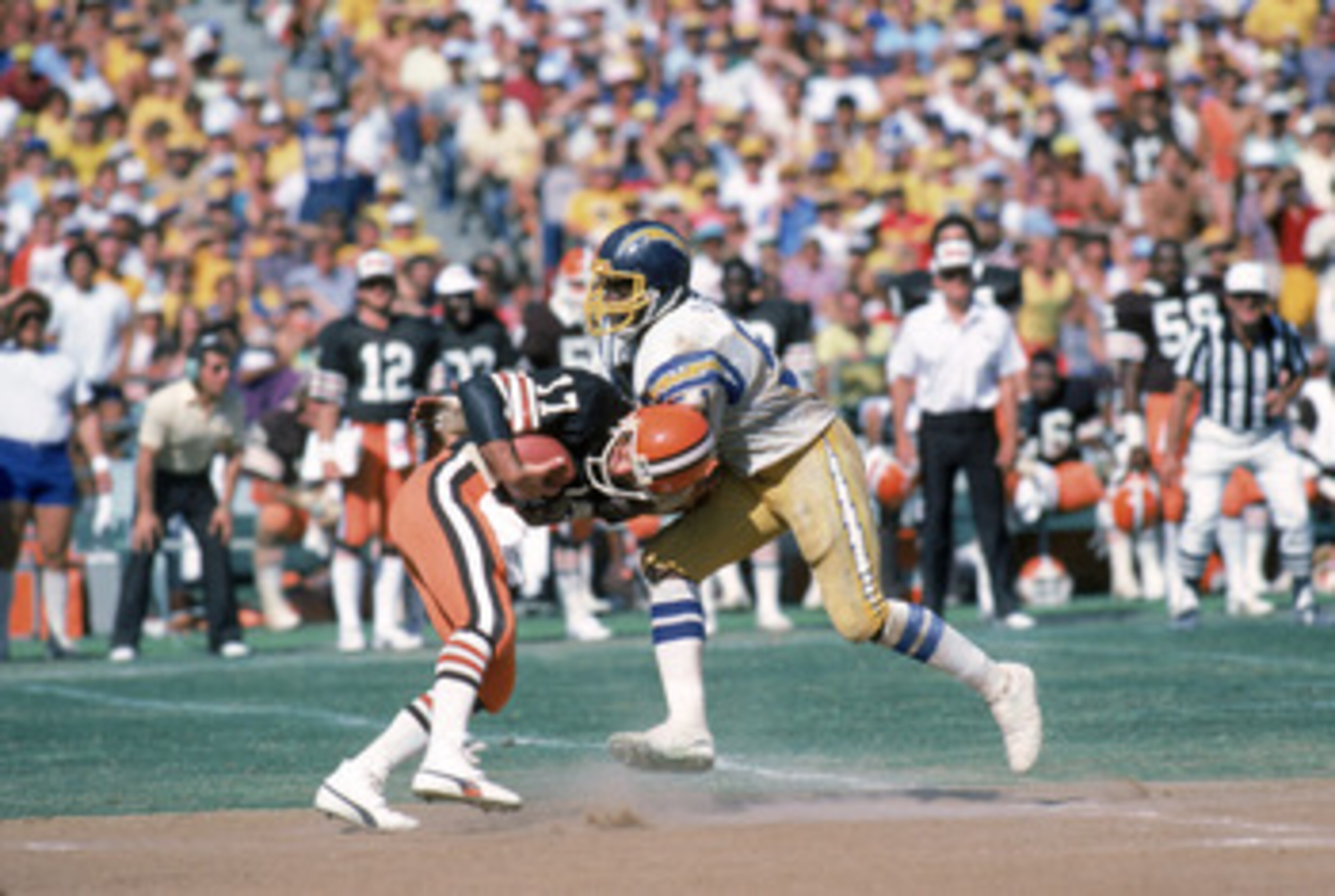SAN DIEGO - SEPTEMBER 25:  Linebacker Woodrow Lowe #51 of the San Diego Chargers sacks quarterback Brian Sipe #17 of the Cleveland Browns during a game at Jack Murphy Stadium on September 25, 1983 in San Diego, California.  The Browns won 30-24.  (Photo b