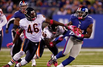EAST RUTHERFORD, NJ - OCTOBER 03:  Hakeem Nicks #88 of the New York Giants runs with the ball against Chris Harris #46 and Charles Tillman #33 of the Chicago Bears at New Meadowlands Stadium on October 3, 2010 in East Rutherford, New Jersey.  (Photo by Mi