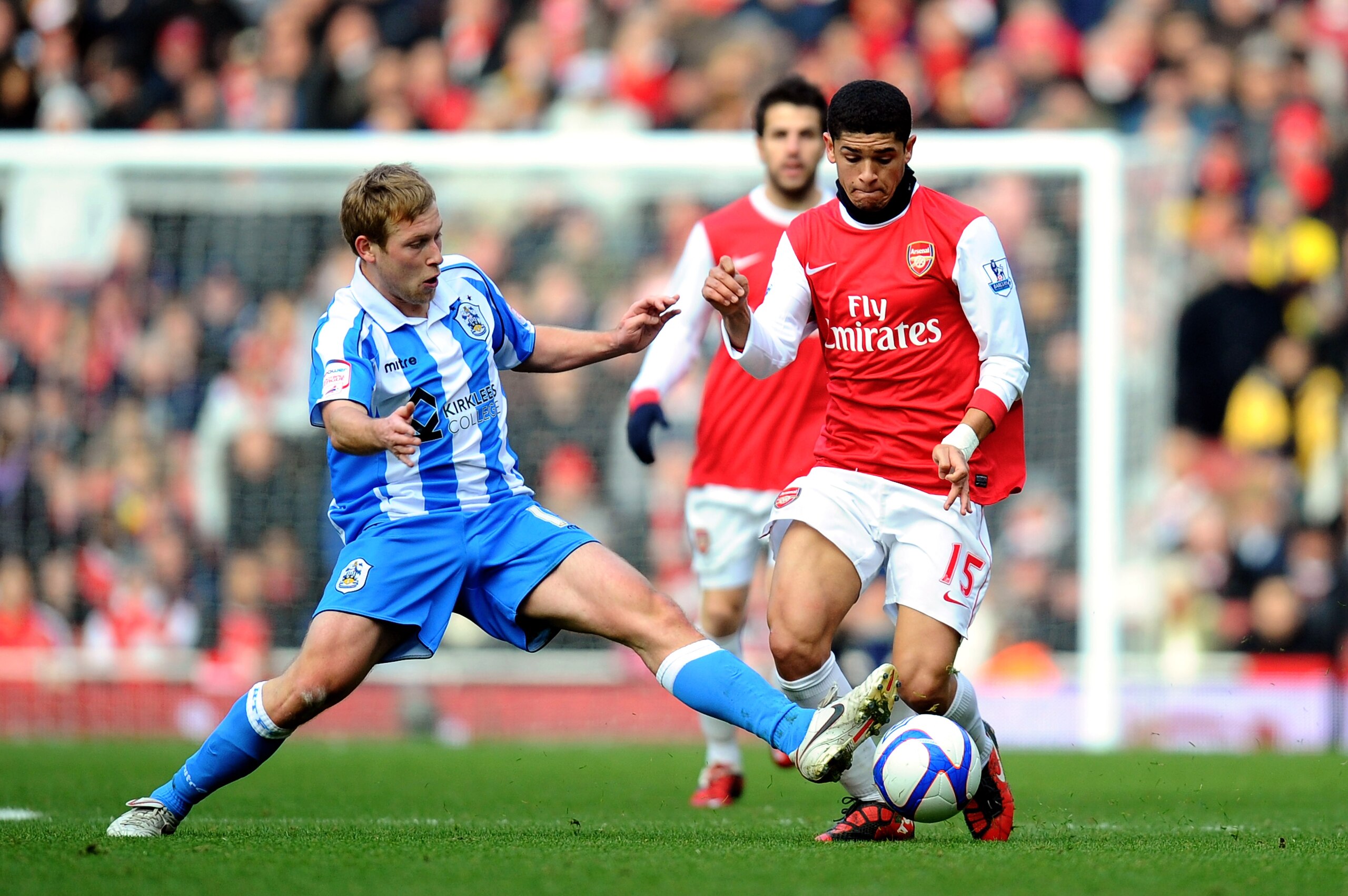 LONDON, ENGLAND - JANUARY 30:  Denilson of Arsenal is tackled by Scott Arfield of Huddersfield during the FA Cup sponsored by E.ON fourth round match between Arsenal and Huddersfield Town at The Emirates Stadium on January 30, 2011 in London, England.  (P