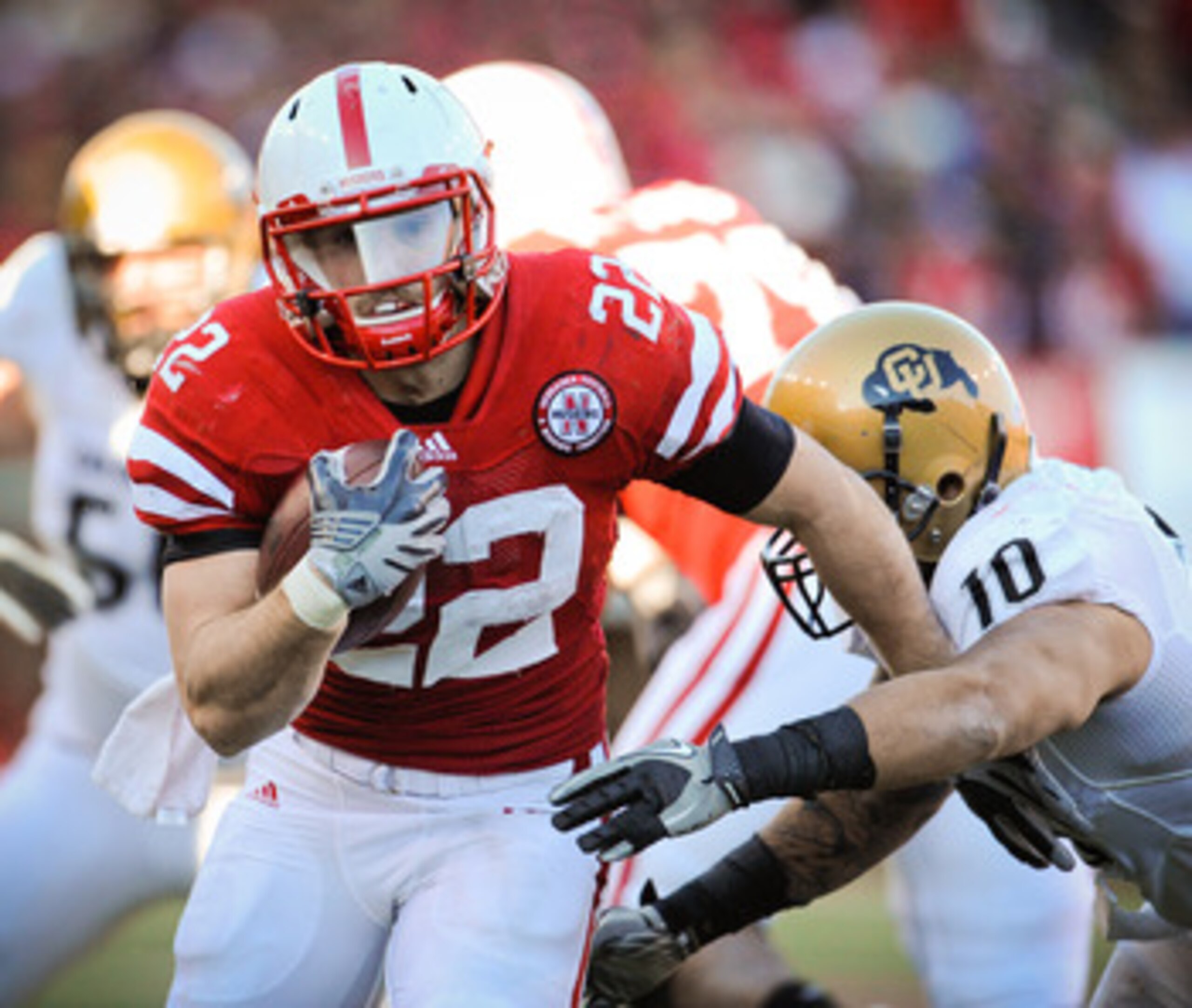LINCOLN, NE - NOVEMBER 26: Rex Burkhead #22 of the Nebraska Cornhuskers runs past Michael Sipili #10 of the Colorado Buffaloes during the first half of their game at Memorial Stadium on November 26, 2010 in Lincoln, Nebraska. (Photo by Eric Francis/Getty LINCOLN, NE - NOVEMBER 26: Rex Burkhead #22 of the Nebraska Cornhuskers runs past Michael Sipili #10 of the Colorado Buffaloes during the first half of their game at Memorial Stadium on November 26, 2010 in Lincoln, Nebraska. (Photo by Eric Francis/Getty
