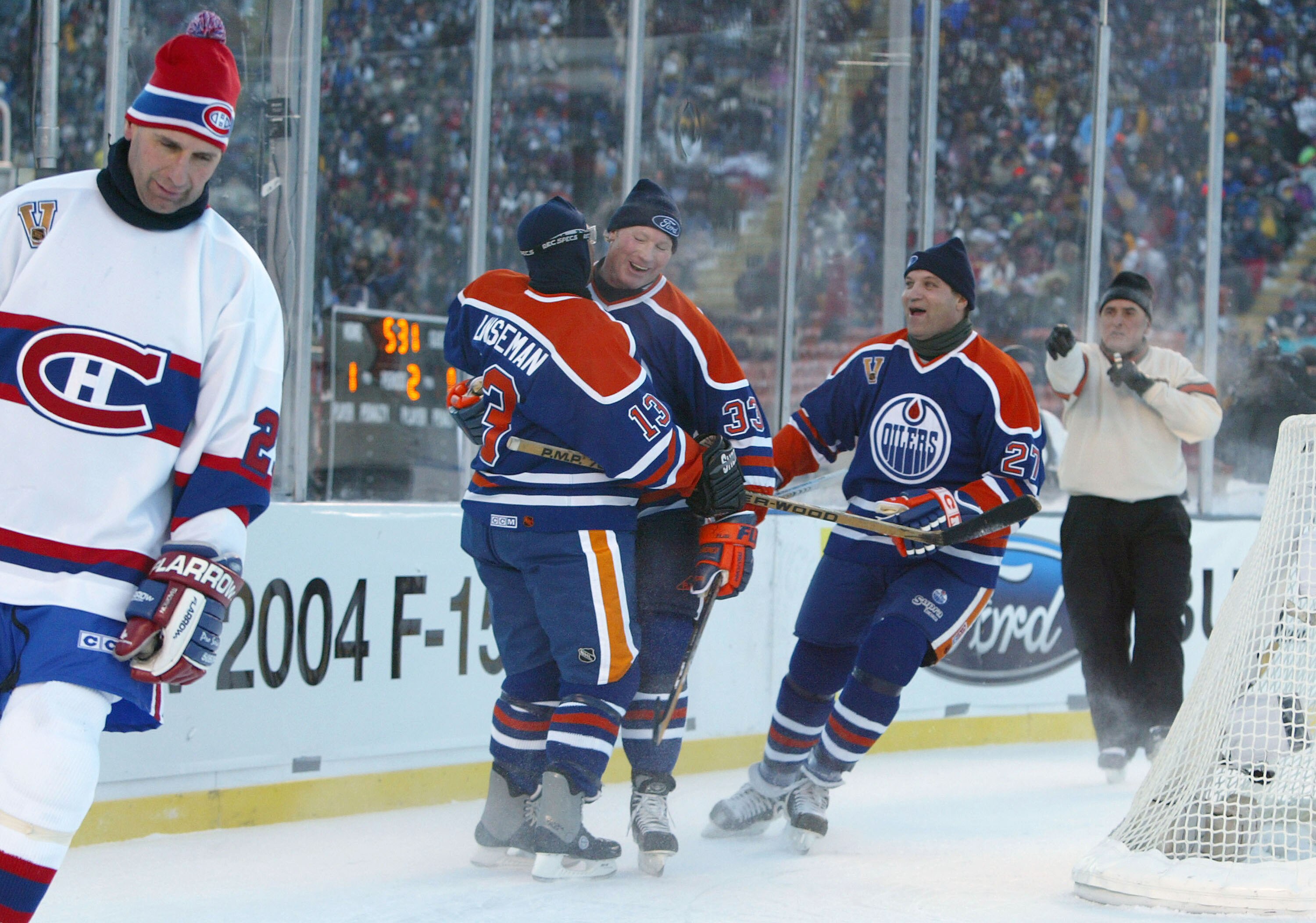 EDMONTON, CANADA - NOVEMBER 22:  Teammates Ken Linseman #13, Marty McSorley #33 and Dave Semenko #27 of the Edmonton Oilers celebrate a goal as Gaston Gingras (L) of the Montreal Canadiens skates away during the Molson Canadien Heritage Classic Megastars