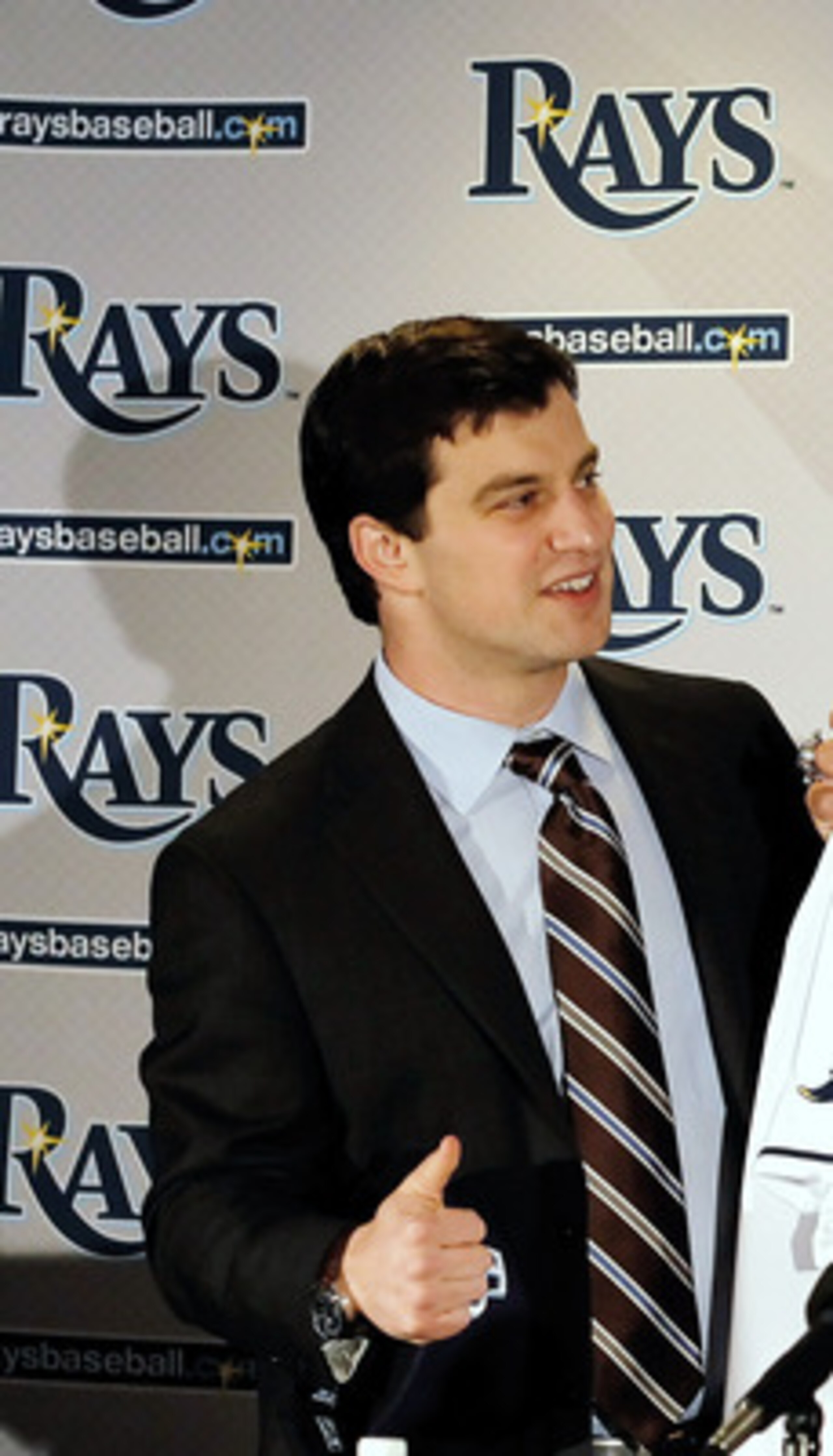 ST PETERSBURG, FL - FEBRUARY 01:  Executive Vice President of Baseball Operations Andrew Friedma (L) poses with Johnny Damon #22 of the Tampa bay Rays during a press conference at Tropicana Field on February 1, 2011 in St Petersburg, Florida.  (Photo by J