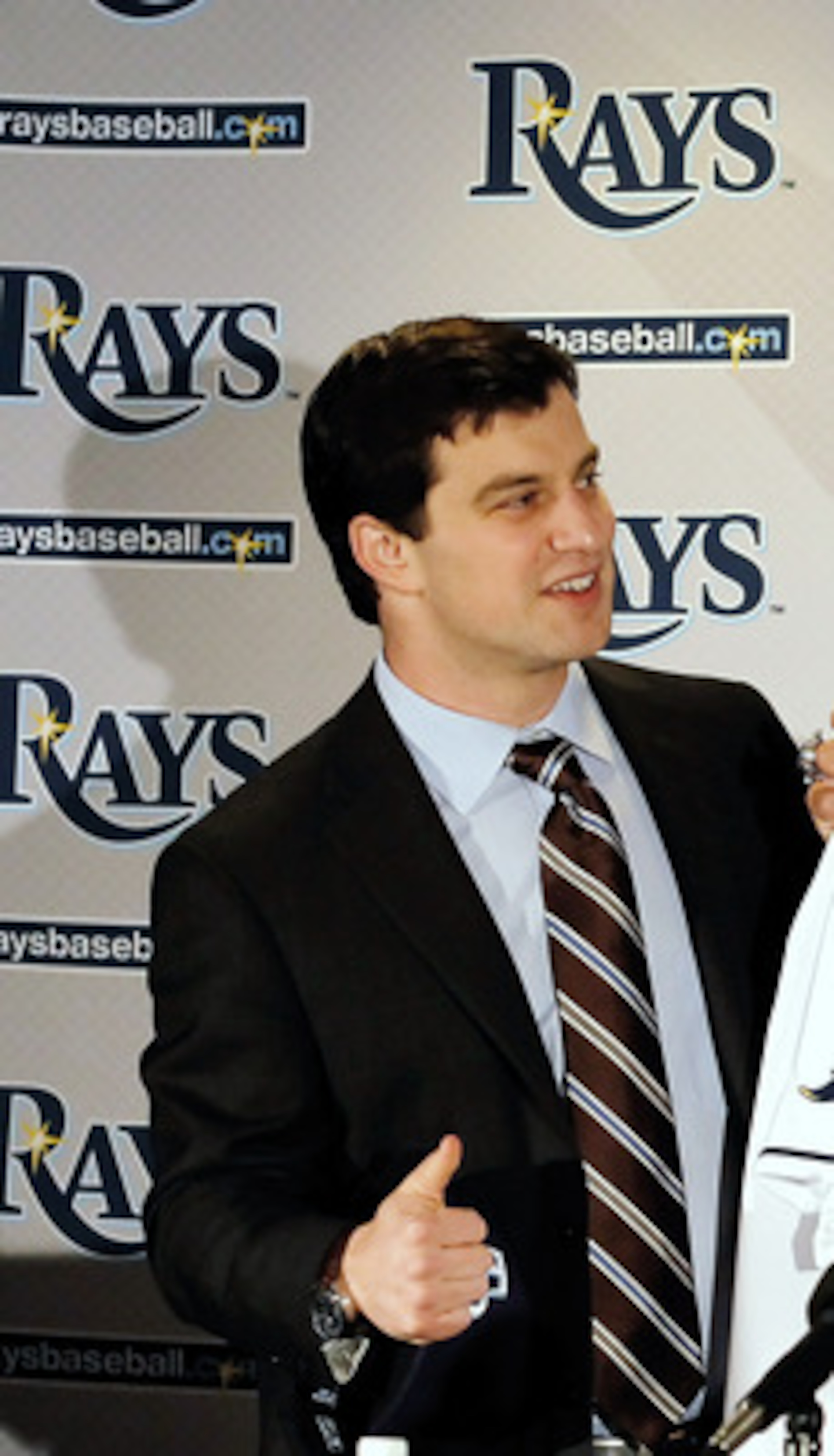 ST PETERSBURG, FL - FEBRUARY 01:  Executive Vice President of Baseball Operations Andrew Friedma (L) poses with Johnny Damon #22 of the Tampa bay Rays during a press conference at Tropicana Field on February 1, 2011 in St Petersburg, Florida.  (Photo by J