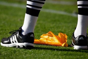 TUSCALOOSA, AL - NOVEMBER 07:  An official stands over a penalty flag during the game between the Alabama Crimson Tide and the Louisiana State University Tigers at Bryant-Denny Stadium on November 7, 2009 in Tuscaloosa, Alabama.  (Photo by Kevin C. Cox/Ge