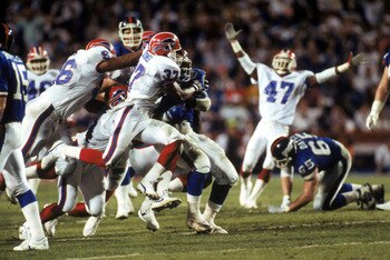 TAMPA, FL - JANUARY 27:  Cornerback Nate Odomes #37 of the Buffalo Bills tackles running back Ottis Anderson #24 of the New York Giants during Super Bowl XXV at Tampa Stadium on January 27, 1991 in Tampa, Florida. The Giants defeated the Bills 20-19.  (Ph