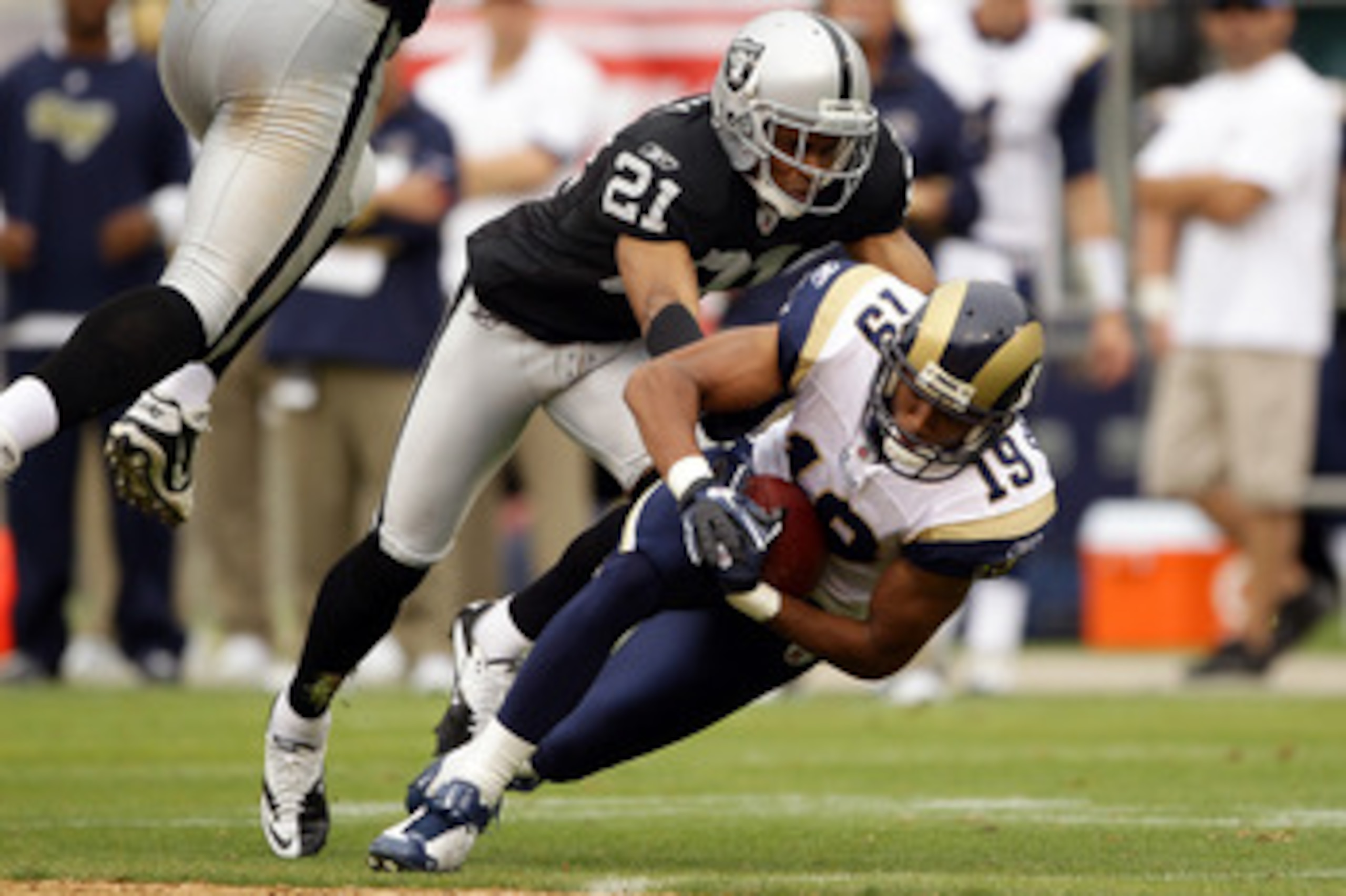 OAKLAND, CA - SEPTEMBER 19:  Laurent Robinson #19 of the St. Louis Rams is tackled by Nnamdi Asomugha #21 of the Oakland Raiders at the Oakland-Alameda County Coliseum on September 19, 2010 in Oakland, California.  (Photo by Ezra Shaw/Getty Images)
