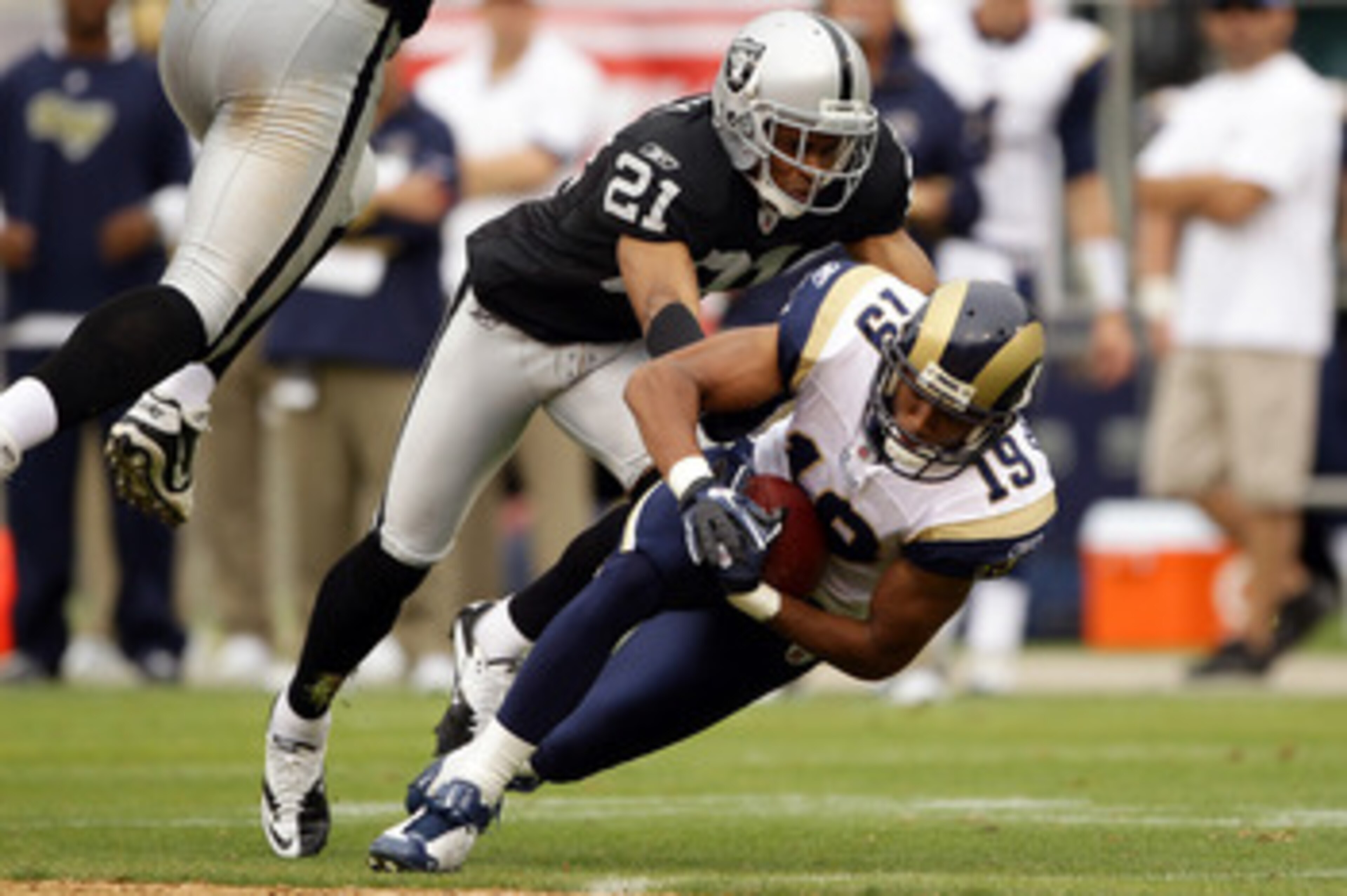 OAKLAND, CA - SEPTEMBER 19:  Laurent Robinson #19 of the St. Louis Rams is tackled by Nnamdi Asomugha #21 of the Oakland Raiders at the Oakland-Alameda County Coliseum on September 19, 2010 in Oakland, California.  (Photo by Ezra Shaw/Getty Images)